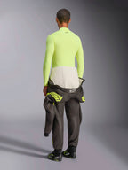 Alpinestars ZX Evo V3 Langarm-Oberteil, Yellow Fluo, Rückansicht eines Models in feuerfester Funktionsunterwäsche mit dunkler Rennanzughose und Stiefeln, professionelle technische Motorsport-Unterwäsche