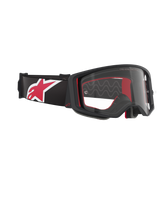 Alpinestars Supertech Corp Goggles, Motocross Goggles, Black Red and Clear, side-angled view featuring a clear lens and black frame, red interior padding, black strap with a large red and white Alpinestars logo, professional off-road eye protection