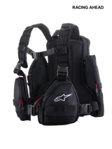 Alpinestars Techdura Tactical Pack, Black and White modular motorcycle backpack, featuring multiple detachable pouches, MOLLE webbing, red zipper pulls, and ergonomic mesh padding, designed for enduro and off-road riding.
