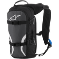 Alpinestars Iguana Hydration Backpack, Off-Road Hydration Pack, Black Anthracite and White, featuring padded mesh shoulder straps, front compression straps with buckles, zippered compartments, and a blue hydration tube with nozzle