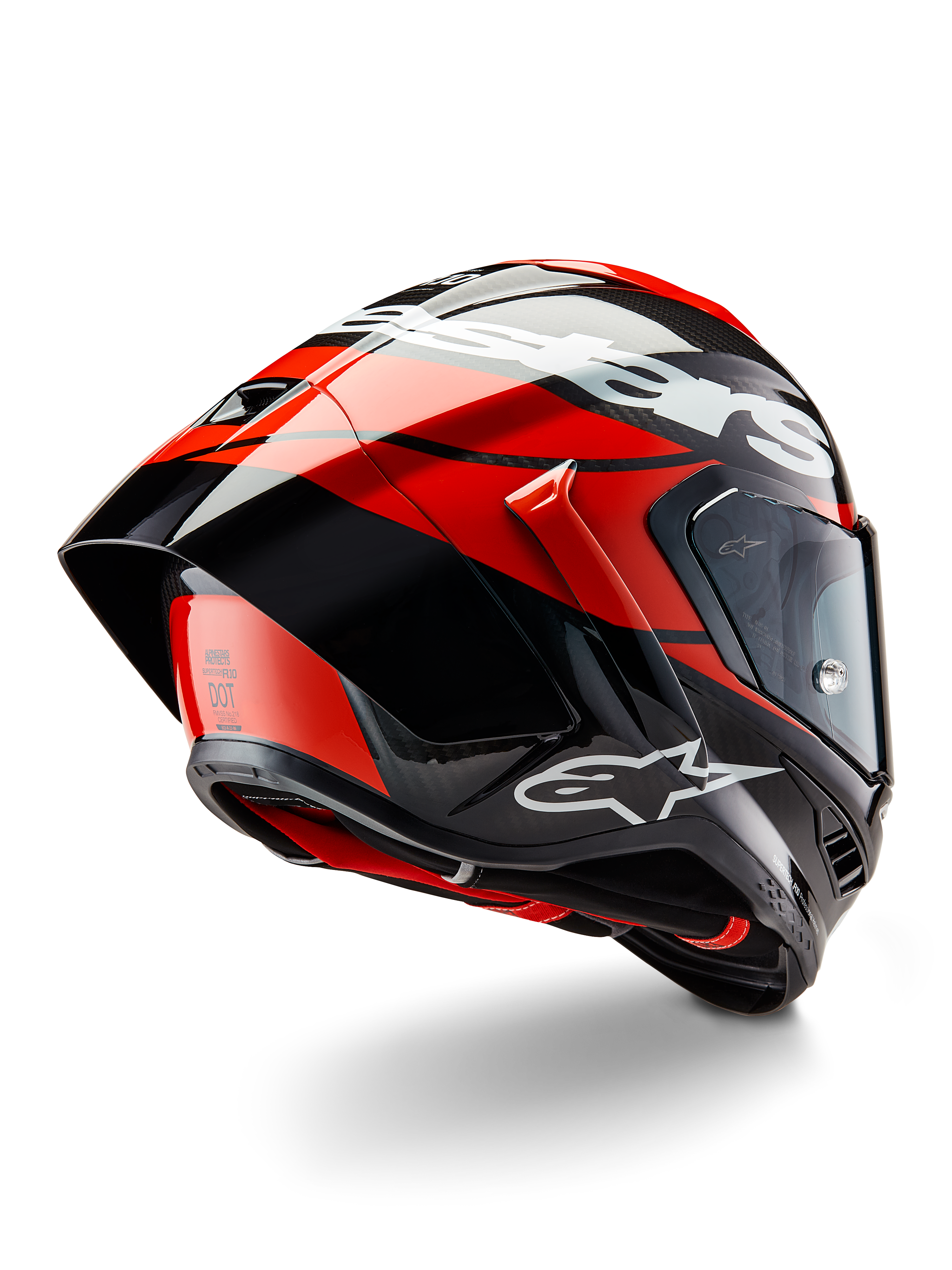 Alpinestars Supertech R10 Element Helm, Schwarz Carbon, Hellrot und Weiß glänzend, Dreiviertelansicht von hinten mit großem aerodynamischem Spoiler und Kohlefaserschale, markante Alpinestars-Logos und DOT-Zertifizierung