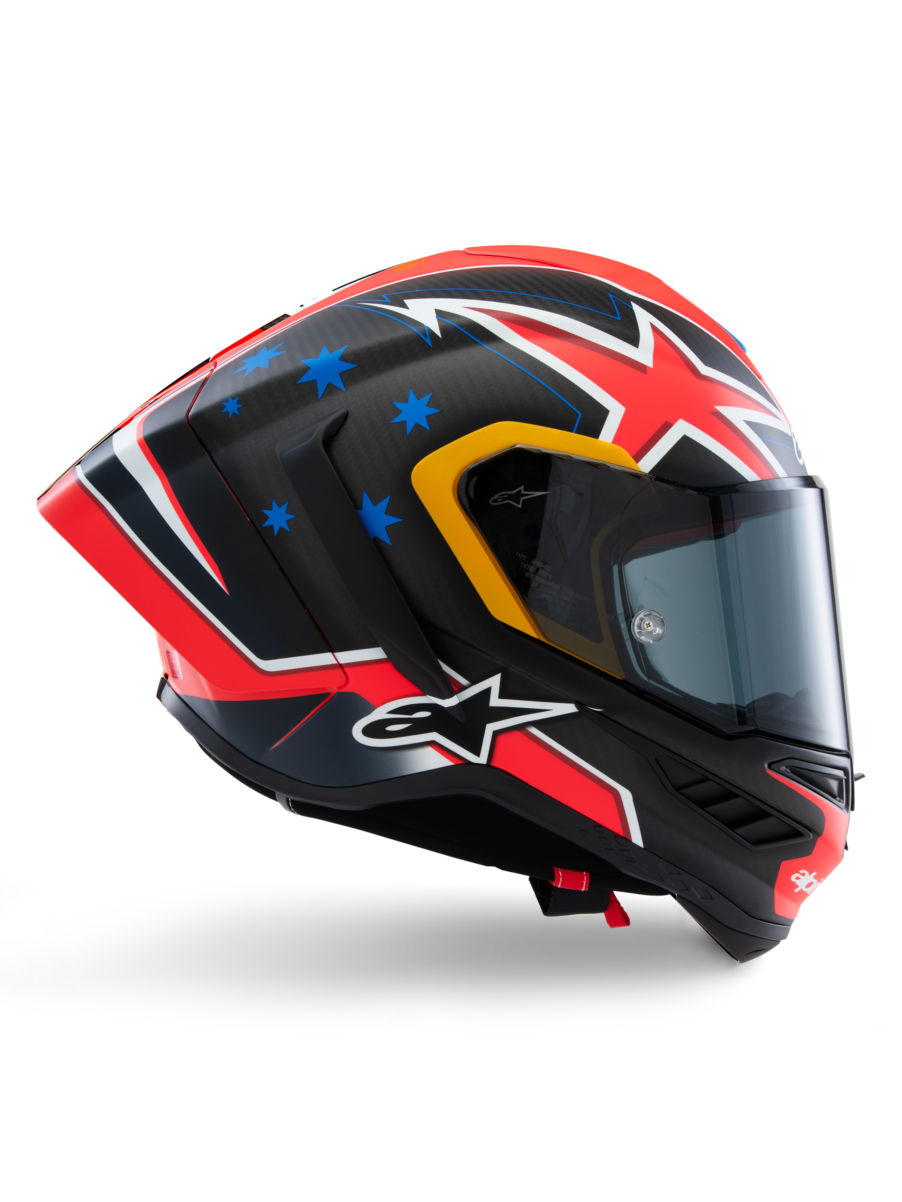 Alpinestars Supertech R10 Miller Limited Edition Helm, Integral-Rennhelm, mattes Carbon mit rot-weiß-blauen Grafiken, blaue Stern-Akzente und gelbe Visier-Details, aerodynamisches Profil mit dunkel getöntem Visier, Hochleistungs-Motorradschutzausrüstung