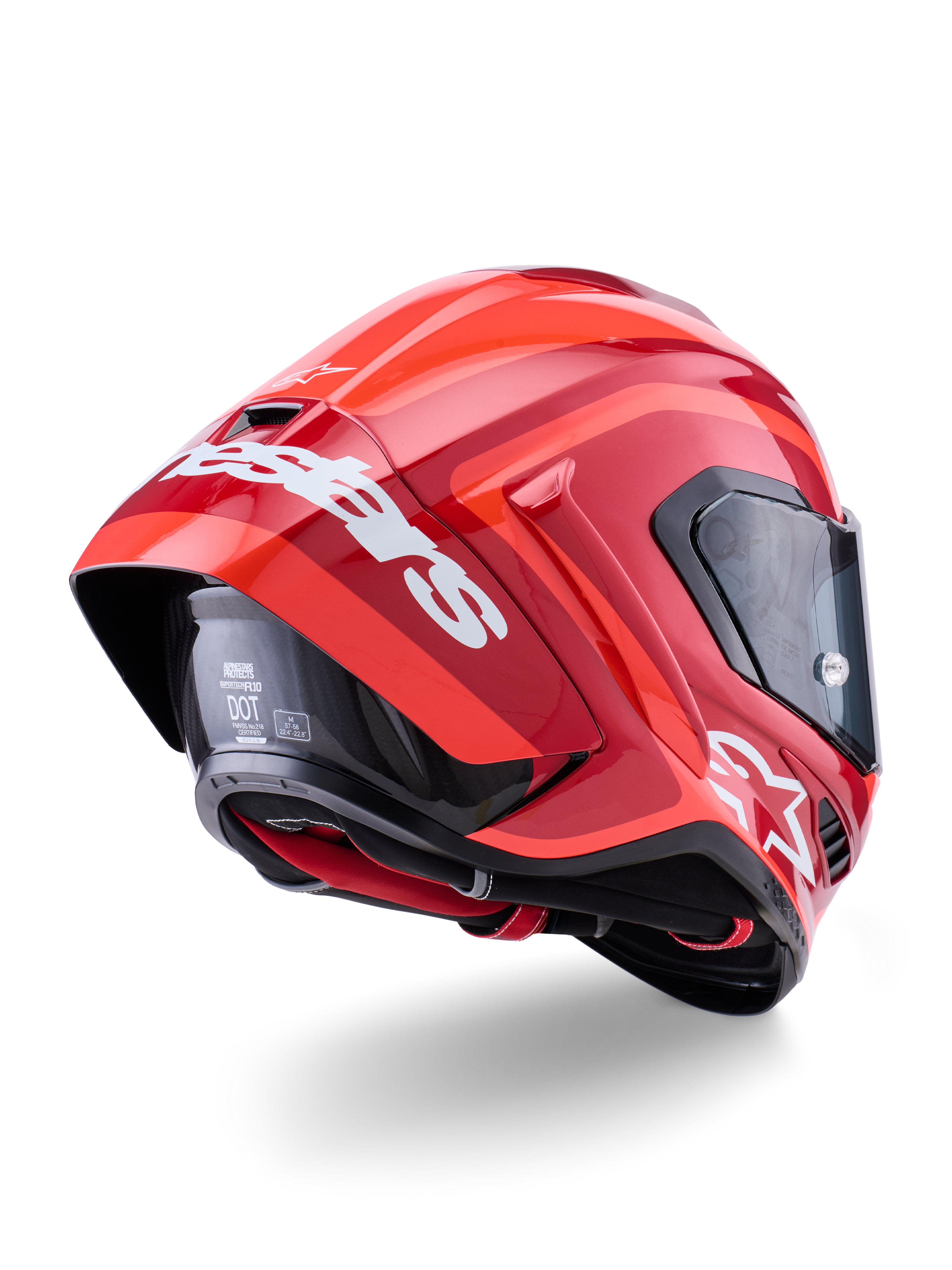 Alpinestars Supertech R10 Arius Helm, Glänzendes Rot mit weißem Branding, rückwärtige Dreiviertel-Ansicht mit aerodynamischem Spoiler, Carbonfaser-Schalenkonstruktion und schlankem Rennprofil mit dunklem Visier