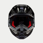 Alpinestars Supertech M10 Solid Helm, Motocross-Helm, Glänzend Schwarzes Carbon, Vorderansicht mit rotem Innenfutter, Carbonfaser-Schale und „ONE GOAL. ONE VISION.“ Slogan im Visierbereich