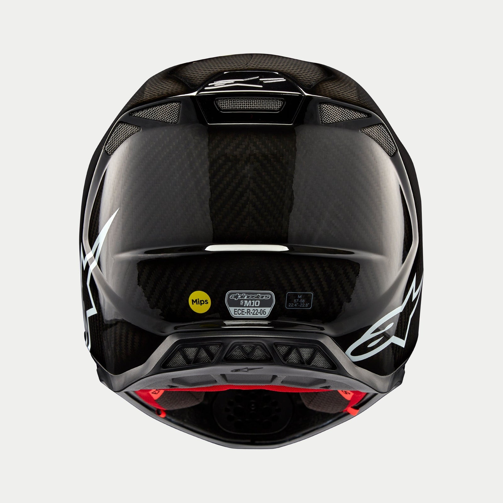 Alpinestars Supertech M10 Solid Helm, Schwarz Glänzendes Carbon, Rückansicht mit glänzendem Carbonfaser-Gewebe, weißes Alpinestars-Logo, MIPS- und ECE-Zertifizierungsaufkleber, aerodynamische Form mit Belüftungsöffnungen