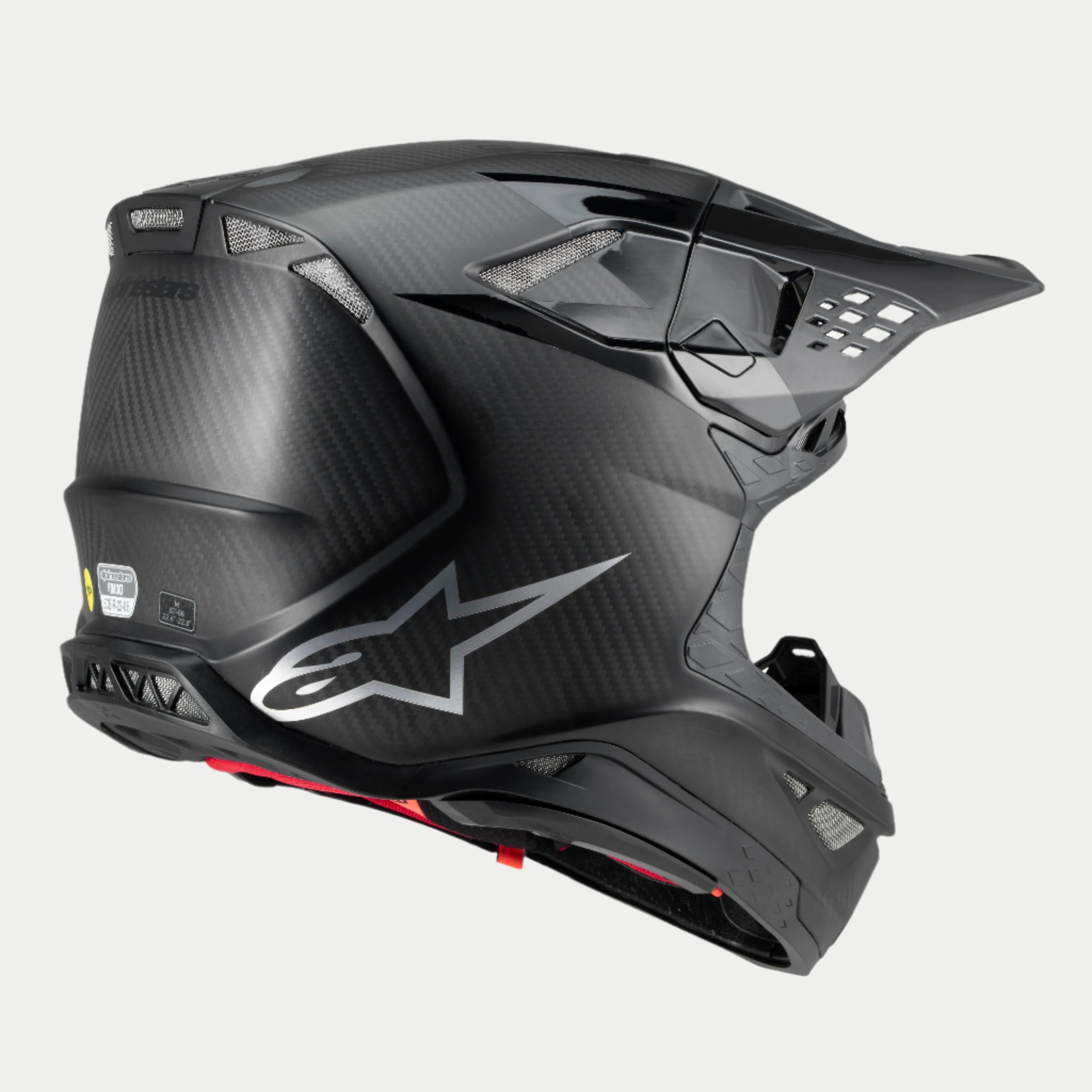 Alpinestars Supertech M10 Fame Helm, Motocross-Helm, Carbon-Schwarz matt und glänzend, Dreiviertel-Rückansicht mit sichtbarer Carbonfaser-Textur, silbernem Logo und mehreren integrierten Belüftungsöffnungen, fortschrittlicher Offroad-Kopfschutz