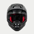 Alpinestars Supertech M10 Fame ECE 22.06 Helm, Motocross-Helm, Schwarz Carbon Matt und Glänzend, Frontansicht mit sichtbarer roter Innenpolsterung, aerodynamische Carbonfaserschale, belüftetes Design für den Offroad-Rennsport