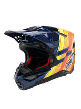 Alpinestars Supertech M10 TLD Edition 25 Helm, Motocross-Helm, Glänzendes Dunkelblau mit orangefarbenen und neongelben Grafiken, rote Innenpolsterung, aerodynamische Schale mit mehreren Belüftungsöffnungen, Troy Lee Designs Branding auf dem Helmschild, professionelle Offroad-Rennausrüstung