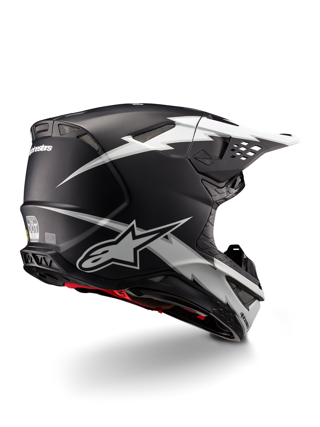 Alpinestars Supertech M10 Ampress Helm, Motocross-Helm, Schwarz-Weiß Matt, mit markanten weißen Blitz-Grafiken auf einer mattschwarzen Schale, Dreiviertel-Rückansicht mit Alpinestars-Logo und Belüftungsöffnungen