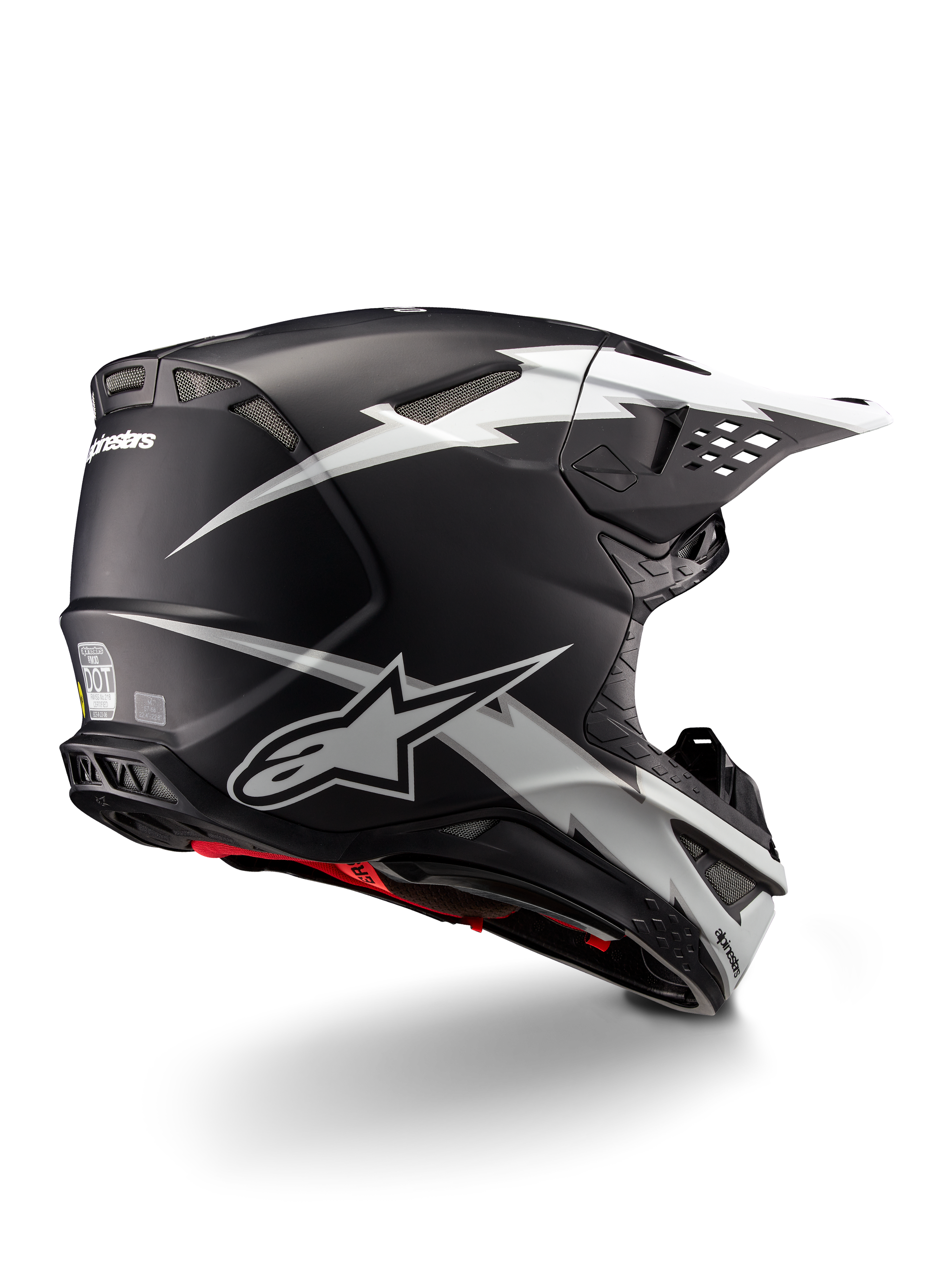 Alpinestars Supertech M10 Ampress Helm, Motocross-Helm, Schwarz-Weiß Matt, mit markanten weißen Blitz-Grafiken auf einer mattschwarzen Schale, Dreiviertel-Rückansicht mit Alpinestars-Logo und Belüftungsöffnungen