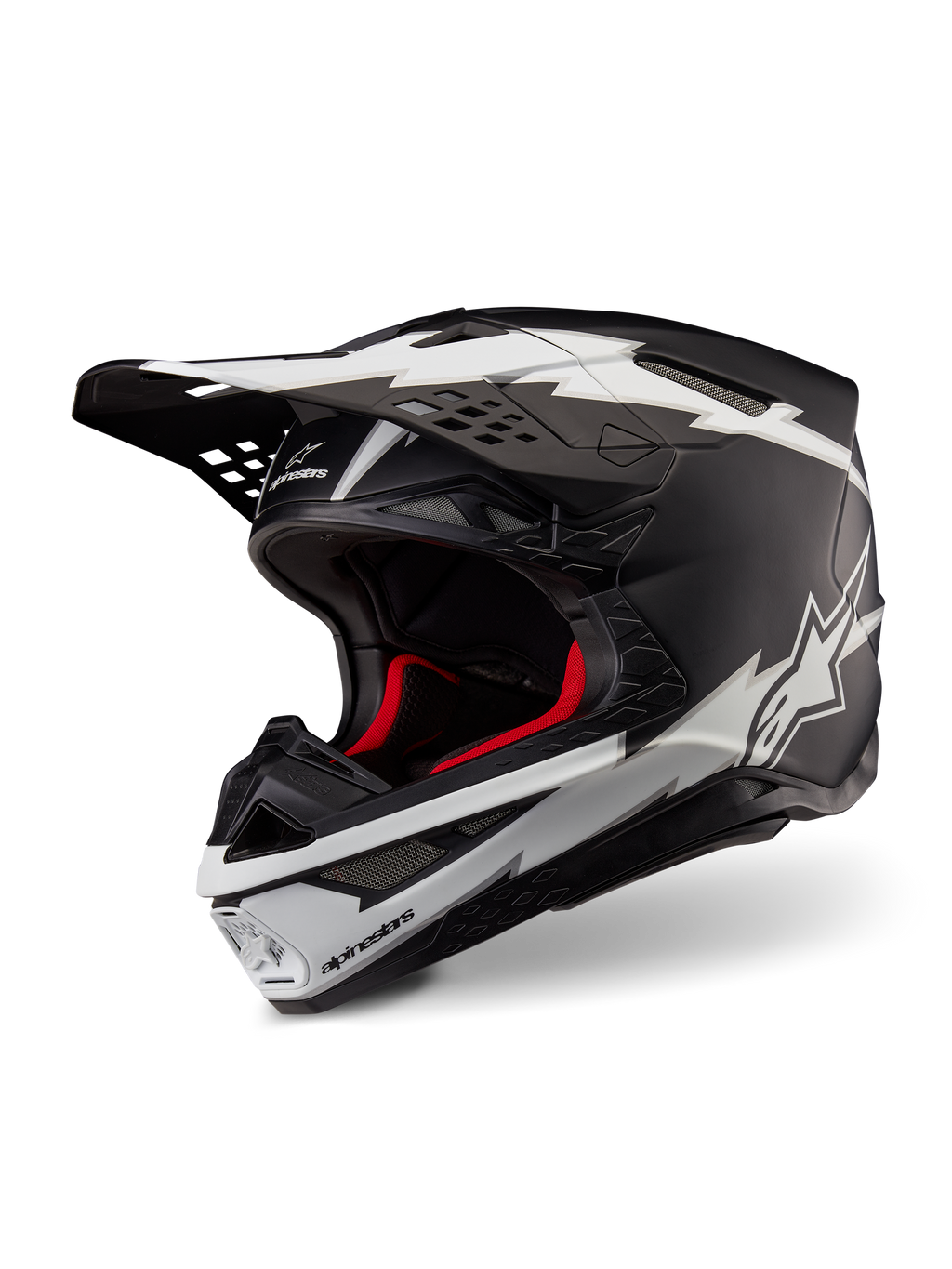 Alpinestars Supertech M10 Ampress Helm, Motocross-Helm, Schwarz und Weiß Matt, mit markanten weißen Blitz-Grafiken und Stern-Logos, rotem Innenfutter, Mehrkomponenten-Karbonschale mit aerodynamischem Profil