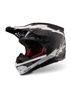 Alpinestars Supertech M10 Ampress Helm, Motocross-Helm, Schwarz und Weiß Matt, mit markanten weißen Blitz-Grafiken und Stern-Logos, rotem Innenfutter, Mehrkomponenten-Karbonschale mit aerodynamischem Profil