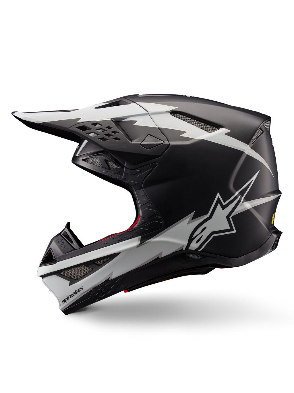 Alpinestars Supertech M10 Ampress Helm, Motocross-Helm, Schwarz-Weiß Matt, Seitenansicht mit markanten weißen Grafiken im Blitz-Stil, aerodynamische Schale mit Belüftungsöffnungen und Visier, fortschrittlicher Offroad-Schutz