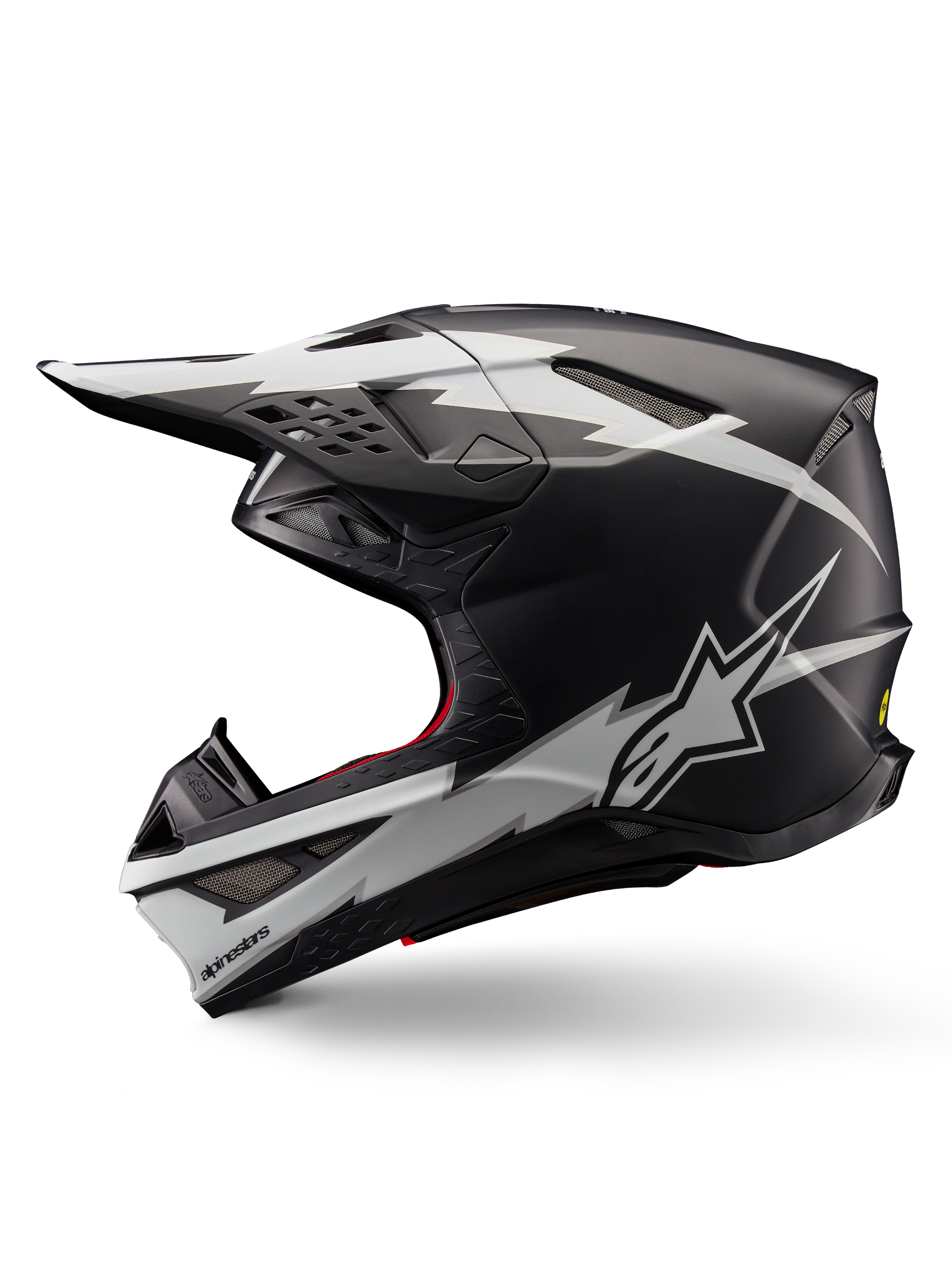 Alpinestars Supertech M10 Ampress Helm, Motocross-Helm, Schwarz-Weiß Matt, Seitenansicht mit markanten weißen Grafiken im Blitz-Stil, aerodynamische Schale mit Belüftungsöffnungen und Visier, fortschrittlicher Offroad-Schutz