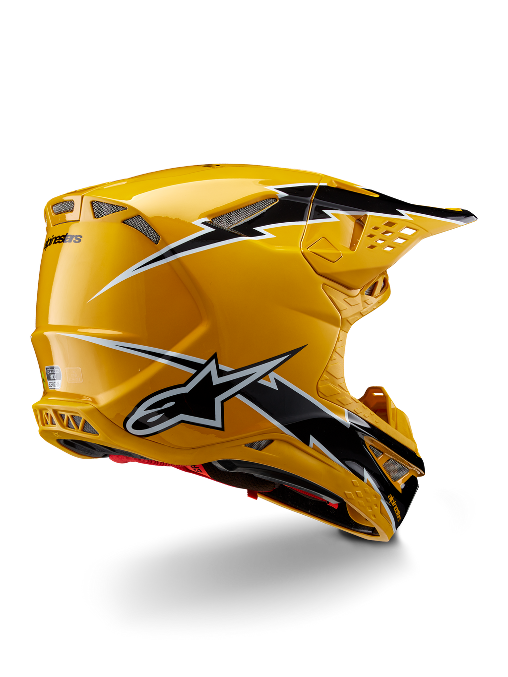 Alpinestars Supertech M10 Ampress Helm, Motocross-Helm, Schwarz Gelb Glänzend, hochglänzendes gelbes Finish mit schwarz-weißen Grafiken im Blitz-Stil, Dreiviertelansicht von hinten mit aerodynamischer Schale und integrierten Belüftungsöffnungen.