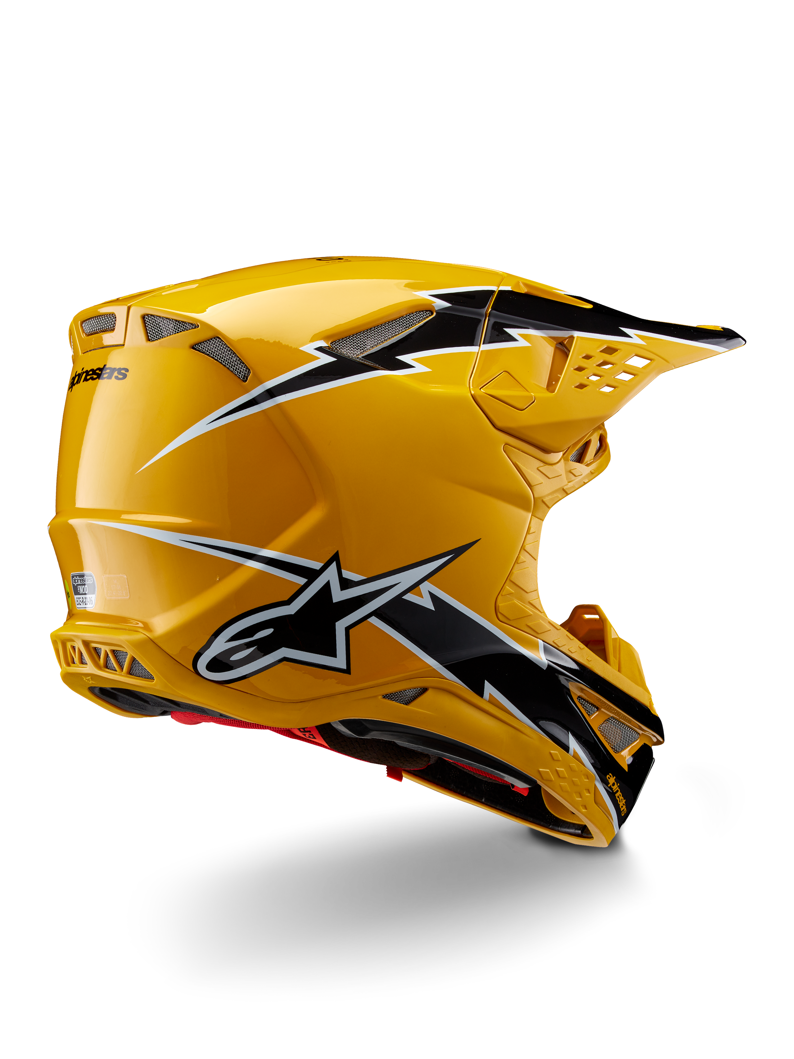 Alpinestars Supertech M10 Ampress Helm, Motocross-Helm, Schwarz Gelb Glänzend, hochglänzendes gelbes Finish mit schwarz-weißen Grafiken im Blitz-Stil, Dreiviertelansicht von hinten mit aerodynamischer Schale und integrierten Belüftungsöffnungen.