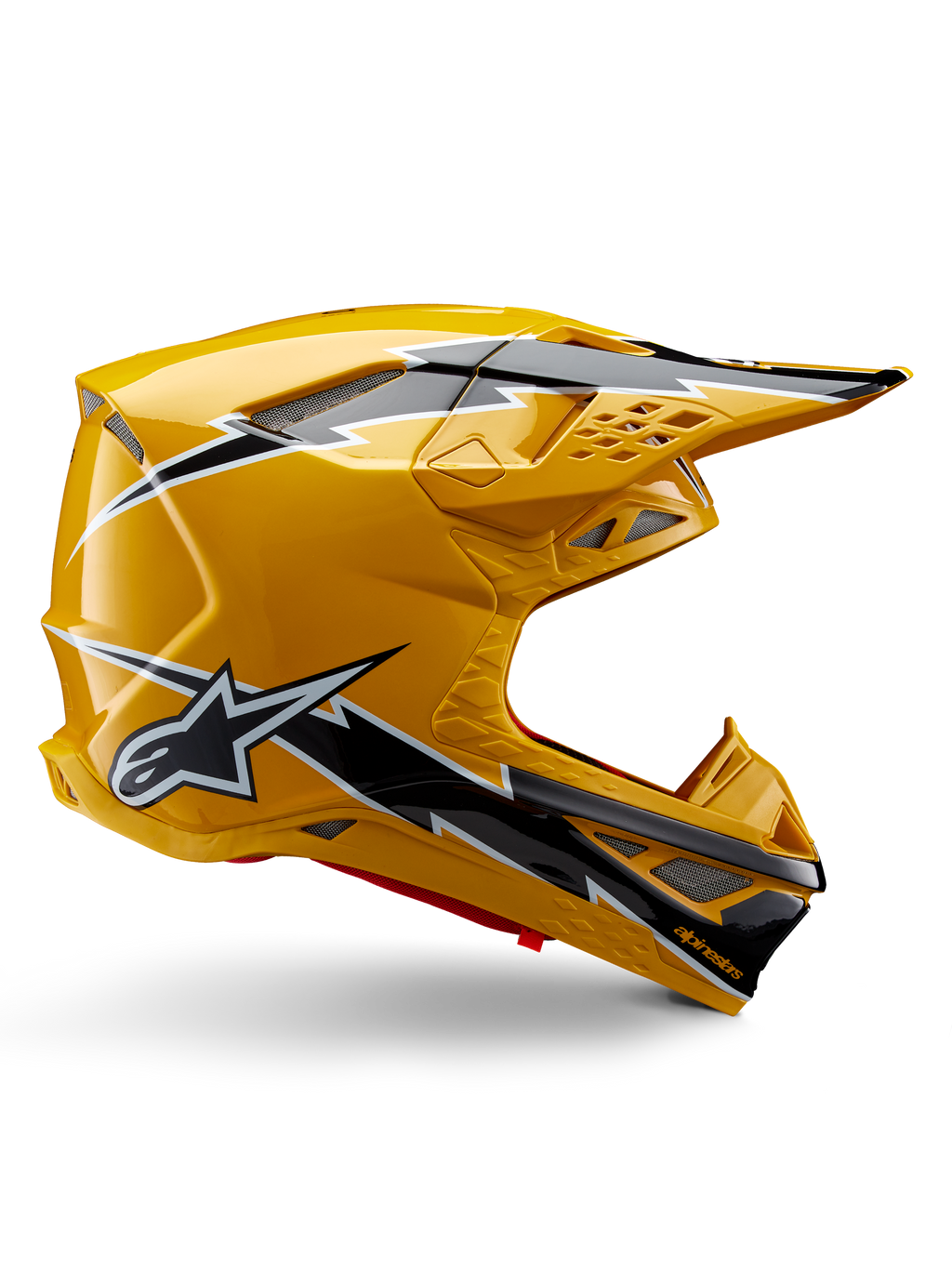Alpinestars Supertech M10 Ampress Helm, Motocross-Helm, Schwarz und Gelb glänzend, Seitenprofil mit markanten schwarz-weißen Blitzgrafiken, Alpinestars Stern-Logo, aerodynamisches Design mit integrierten Belüftungsöffnungen und verstellbarem Visier.