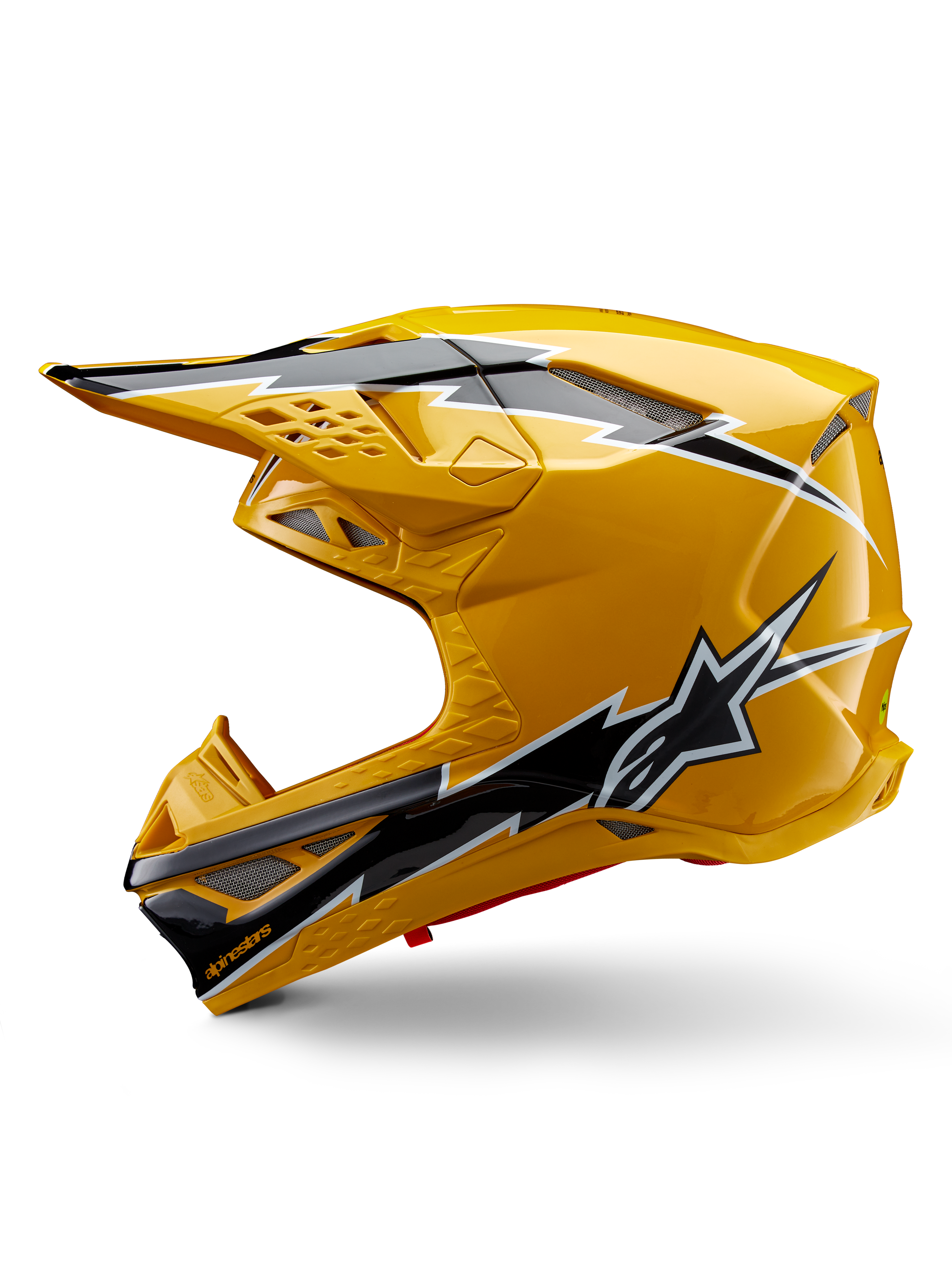 Alpinestars Supertech M10 Ampress Helm, Motocross-Helm, Glänzendes Gelb mit schwarz-weißen Grafiken, Seitenansicht mit markanten eckigen Designs, Alpinestars-Stern-Logo und mehreren Belüftungsöffnungen mit silbernem Mesh, professionelle Offroad-Rennausrüstung