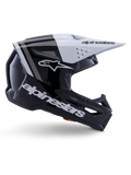 Alpinestars S-M3 Radium Helm, Motocross-Offroad-Helm, Schwarz, Weiß und Grau glänzend, mit einem kantigen aerodynamischen Design und Belüftungsöffnungen, Seitenansicht, glänzende Oberfläche mit grauen Streifen und ein weißes Visier mit Alpinestars-Branding
