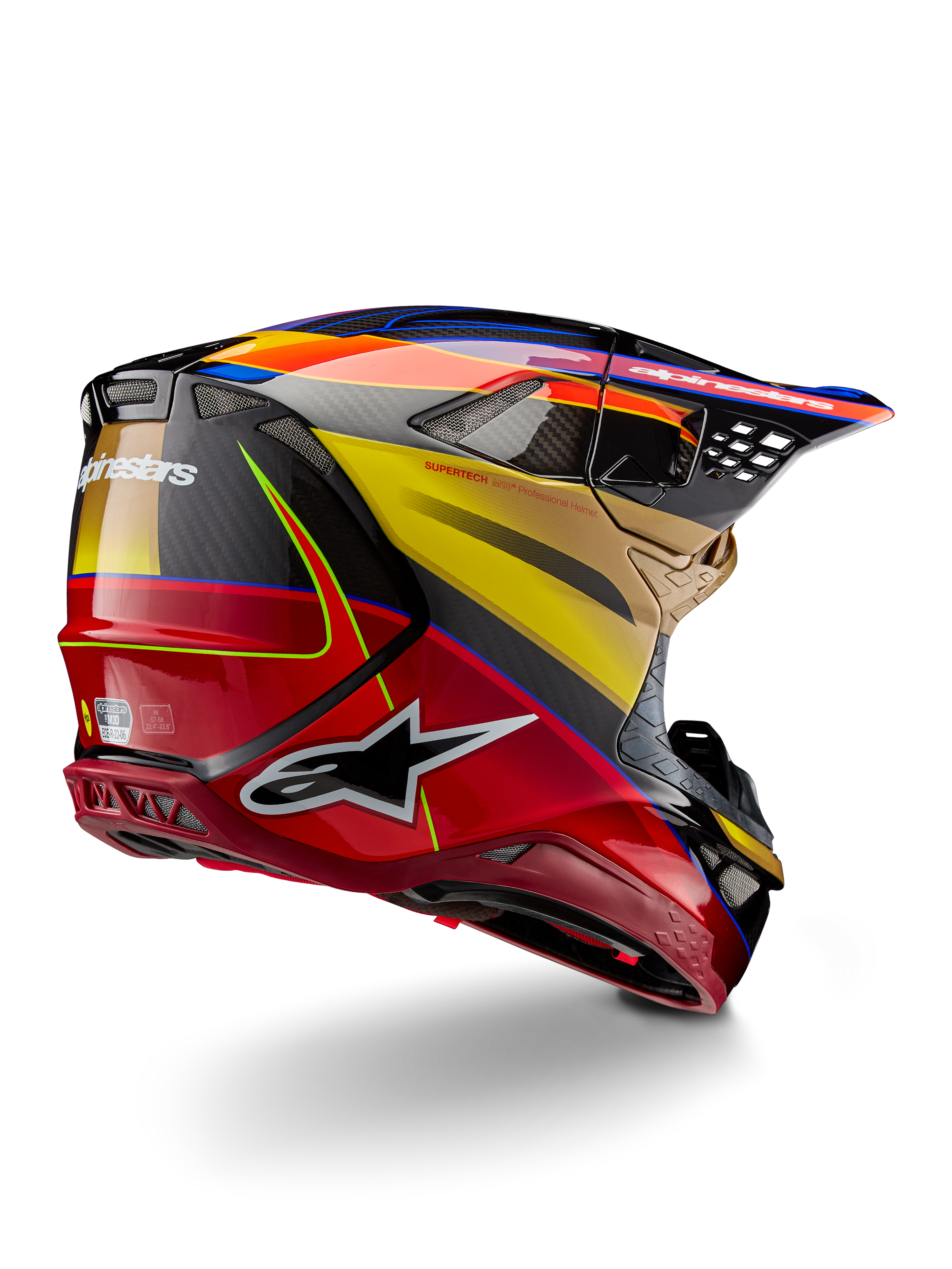 Alpinestars Supertech M10 Era Helm, Motocross-Helm, Goldgelb Rio-Rot Glänzend, Dreiviertelansicht von hinten mit Kohlefaserschale, roten und gelben Grafiken, blauen Akzenten, aerodynamisches Profil mit mehreren Belüftungsöffnungen und markantem Astar-Logo.