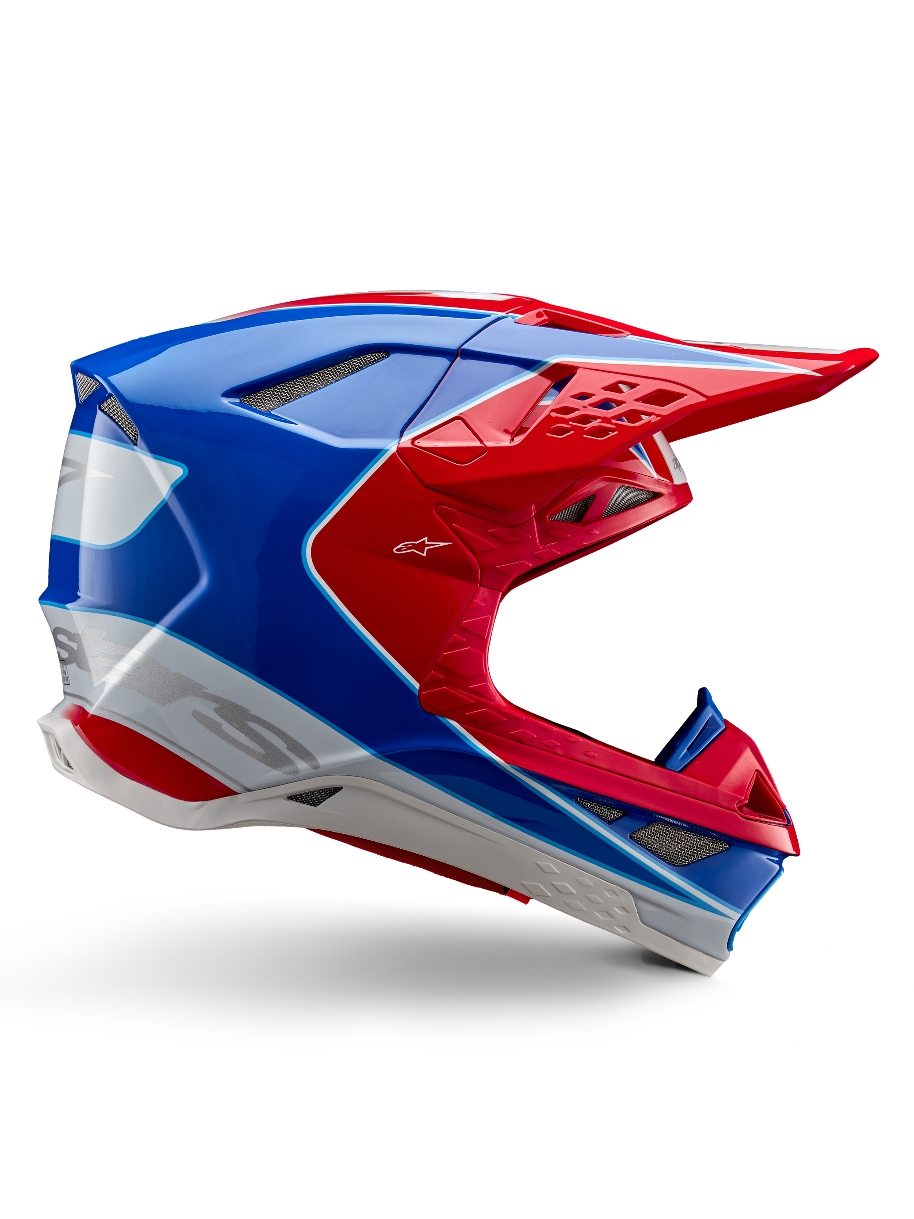 Alpinestars Supertech M10 Aeon Helm, Motocross-Rennhelm, Hellrot, Blau und Weiß, glänzende Oberfläche, aerodynamisches Seitenprofil mit mehreren netzabgedeckten Belüftungsöffnungen, markanten Konturen und Helmschild