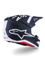 Alpinestars S-M7 Dasher Helmet, Motocross Helmet, Matte Black and White, rear three-quarter view featuring large white A-star logo on the side, bold white branding on top, aerodynamic shell design with visible ventilation ports and red padding.