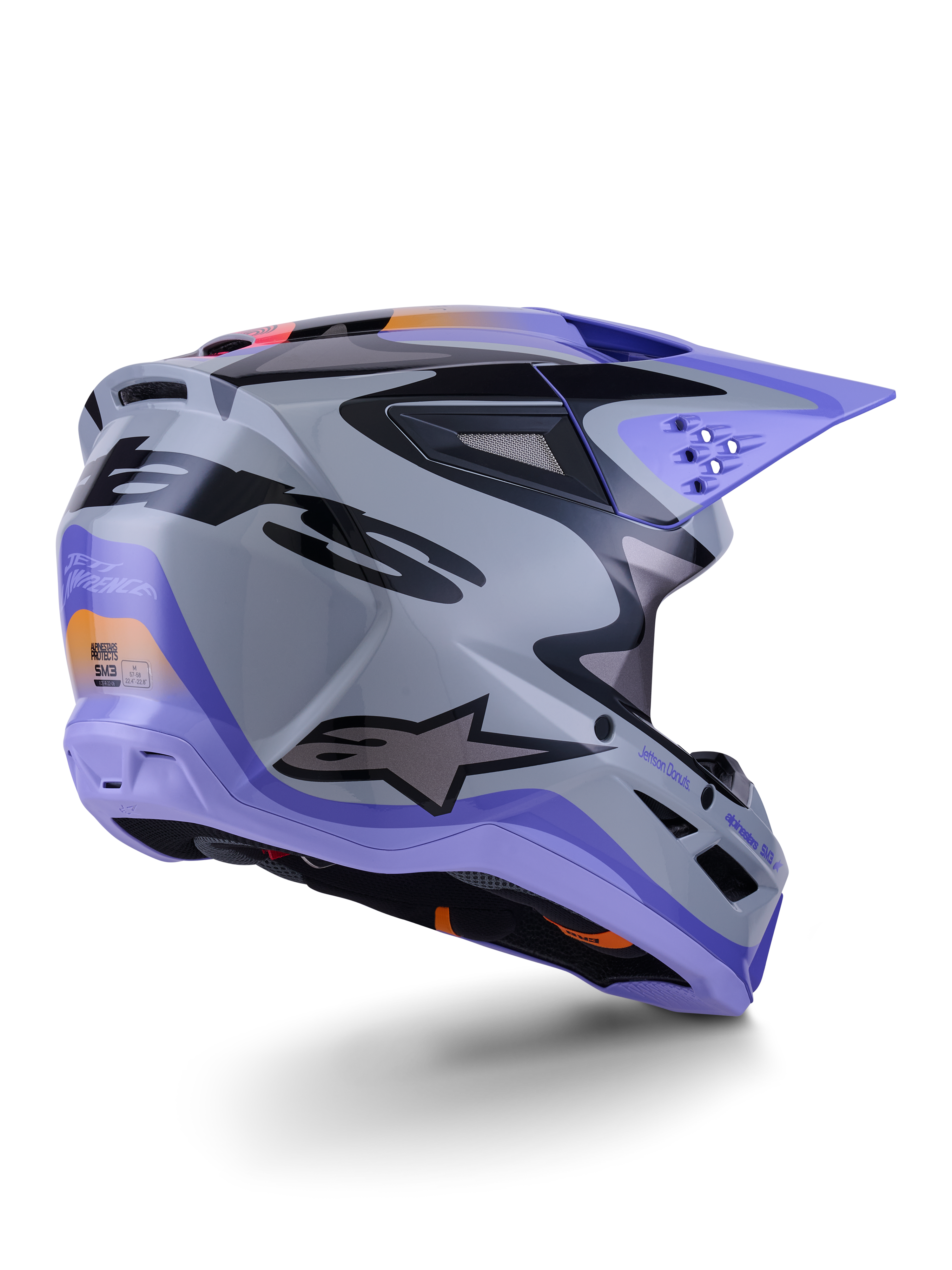 Alpinestars S-M3 Jettson Helm ECE 22.06, Motocross-Helm, Grau, Violett und Schwarz glänzend, Dreiviertelansicht von hinten zeigt die aerodynamische thermo-injizierte Schale mit Belüftungsöffnungen und markantem Grafikdesign