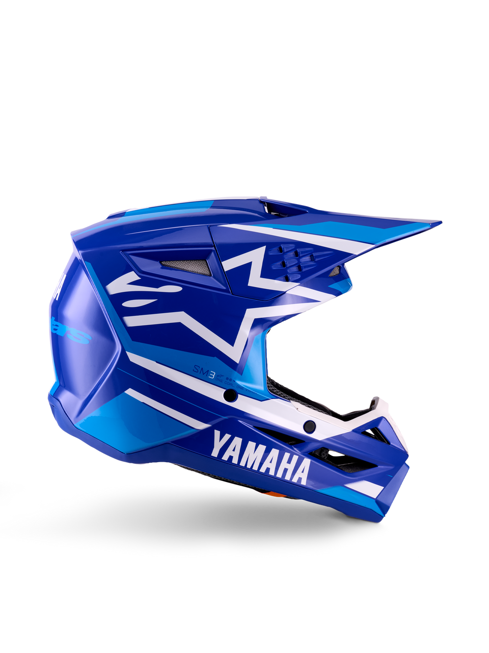 Yamaha S-M3 Jugend-Motocross-Helm, Blau-Weiß glänzend, Seitenansicht mit markantem Yamaha-Branding und Alpinestars-Sternlogo, geometrisches Design mit hellblauen Akzenten, belüftete Schale mit langem Visier, ECE 22.06 zertifizierter Offroad-Kopfschutz