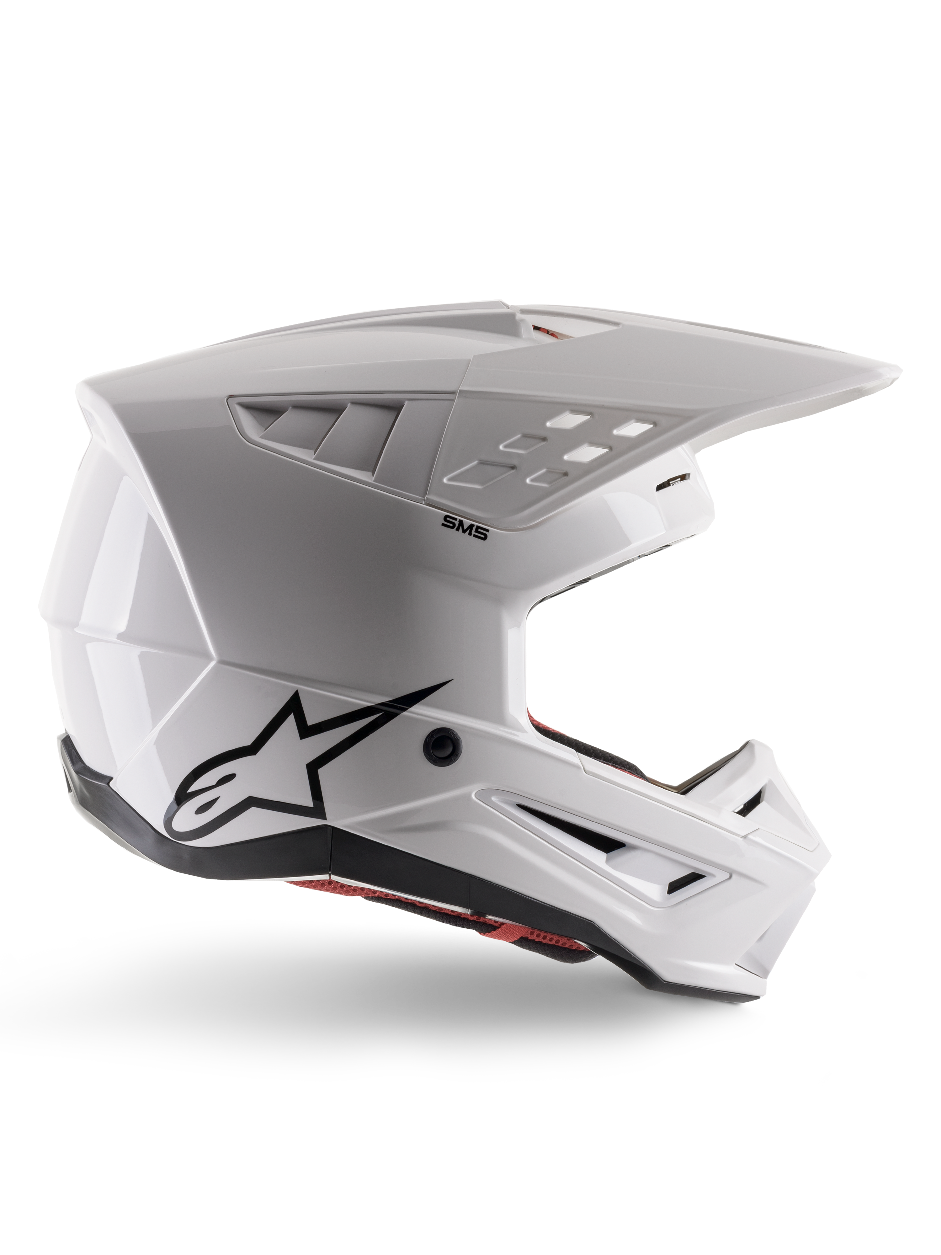Alpinestars S-M5 Solid Helmet ECE 22.06, Motocross Helmet, White Glossy, side profile featuring an angular aerodynamic design, prominent peak visor, integrated air vents, black Astars logo on the rear, and visible red interior padding