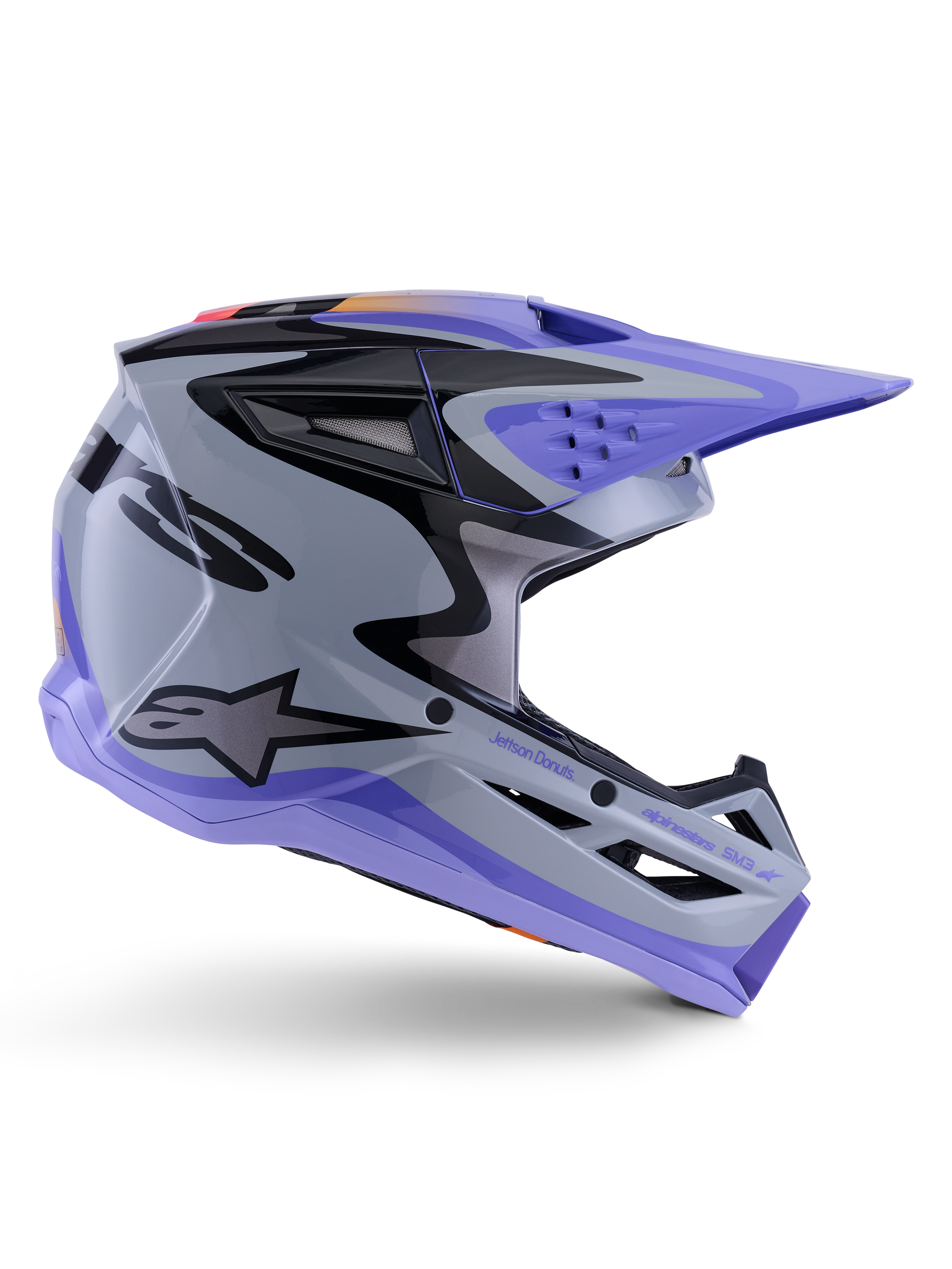 Alpinestars S-M3 Jettson Helm ECE 22.06, Motocross-Helm, Grau, Lila und Schwarz glänzend, Seitenansicht, lila Visier und Kinnschutz, schlanke aerodynamische Schale mit schwarzen Grafiken, mehrere Belüftungsöffnungen und „Jettson Donuts“-Branding auf der Seite.