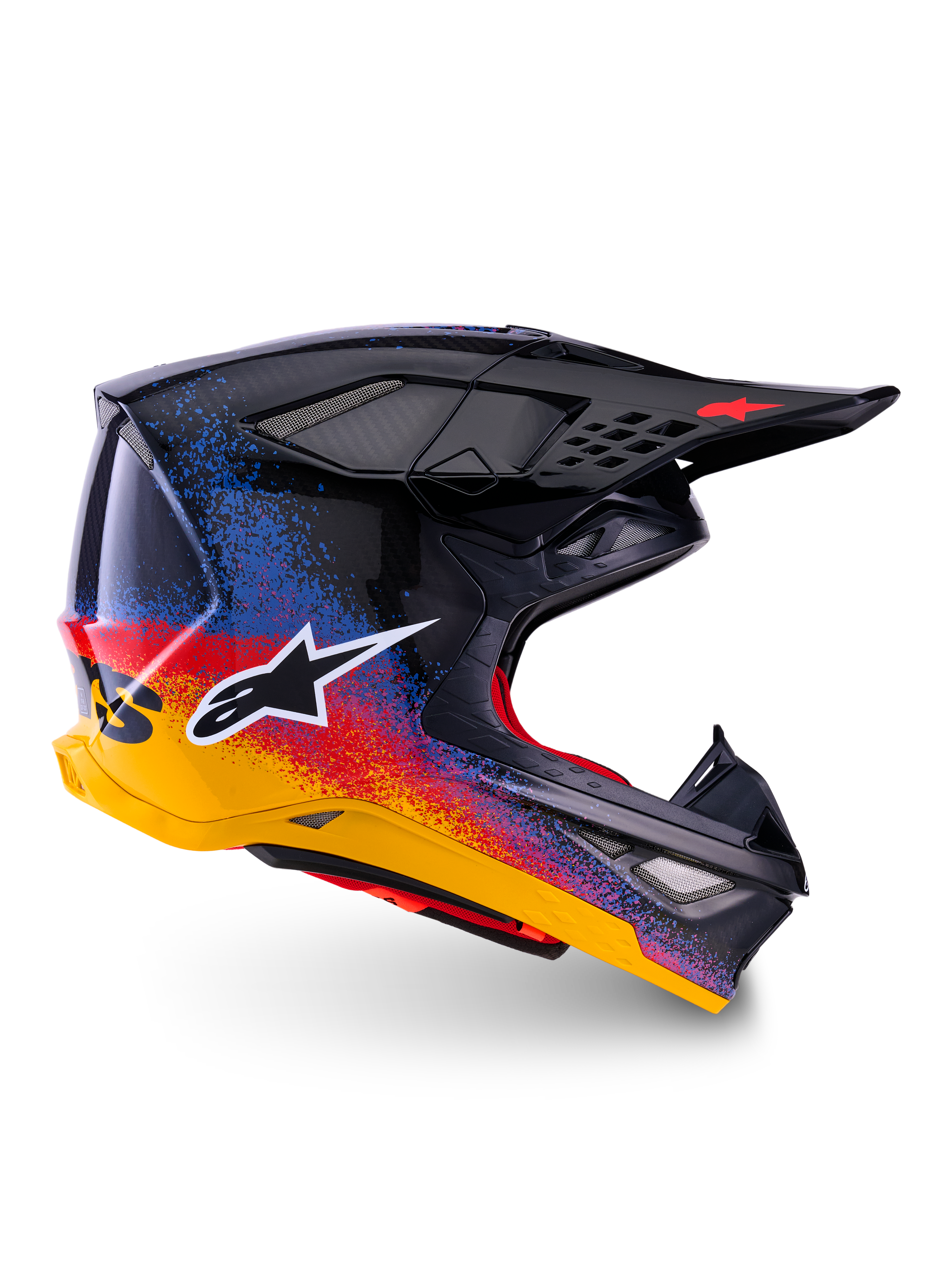 Alpinestars Limited Edition Supertech M10 Black Hole Helm, Motocross-Rennhelm, schwarze Schale mit rot-blau-gelbem Splatter-Farbverlauf, weißes Stern-Logo auf der Seite, aerodynamisches Profil mit netzabgedeckten Belüftungsöffnungen, rote Innenpolsterung und langes schwarzes Visier.
