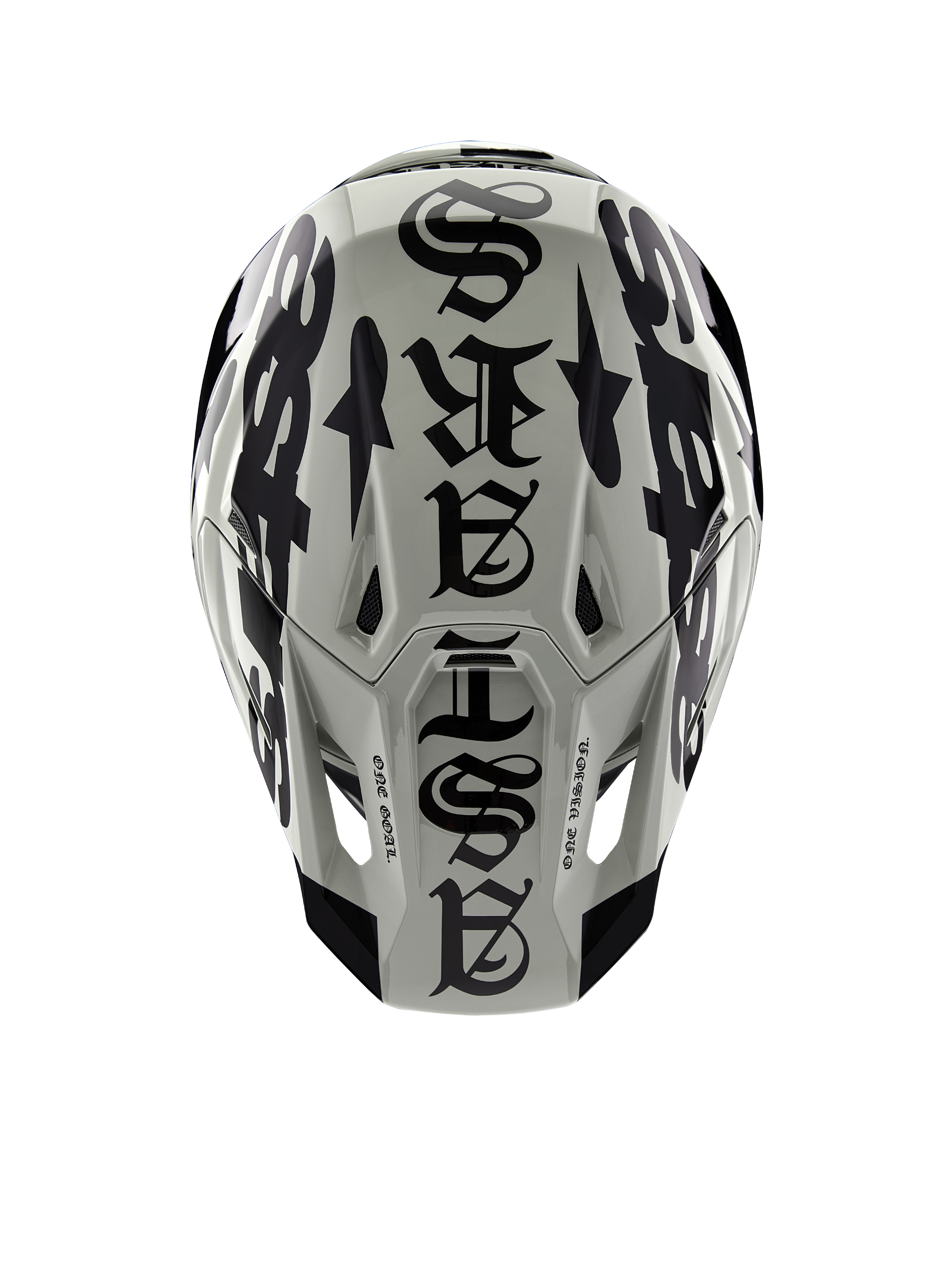 Alpinestars Limited Edition S-M7 Wolf Dust Helm, Draufsicht, glänzendes Finish in Dune und Schwarz, mit markanter Typografie im Gothic-Stil auf der Helmoberseite und „One Goal One Vision“-Details, professioneller Kopfschutz für den Motocross-Rennsport