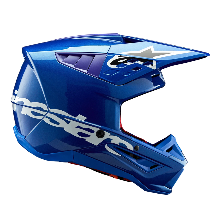 Alpinestars S-M5 Corp Helmet ECE, Blue Glossy motocross helmet, side profile view, bold white Alpinestars branding across the side, purple accents in ventilation ports, lightweight aerodynamic shell for off-road performance