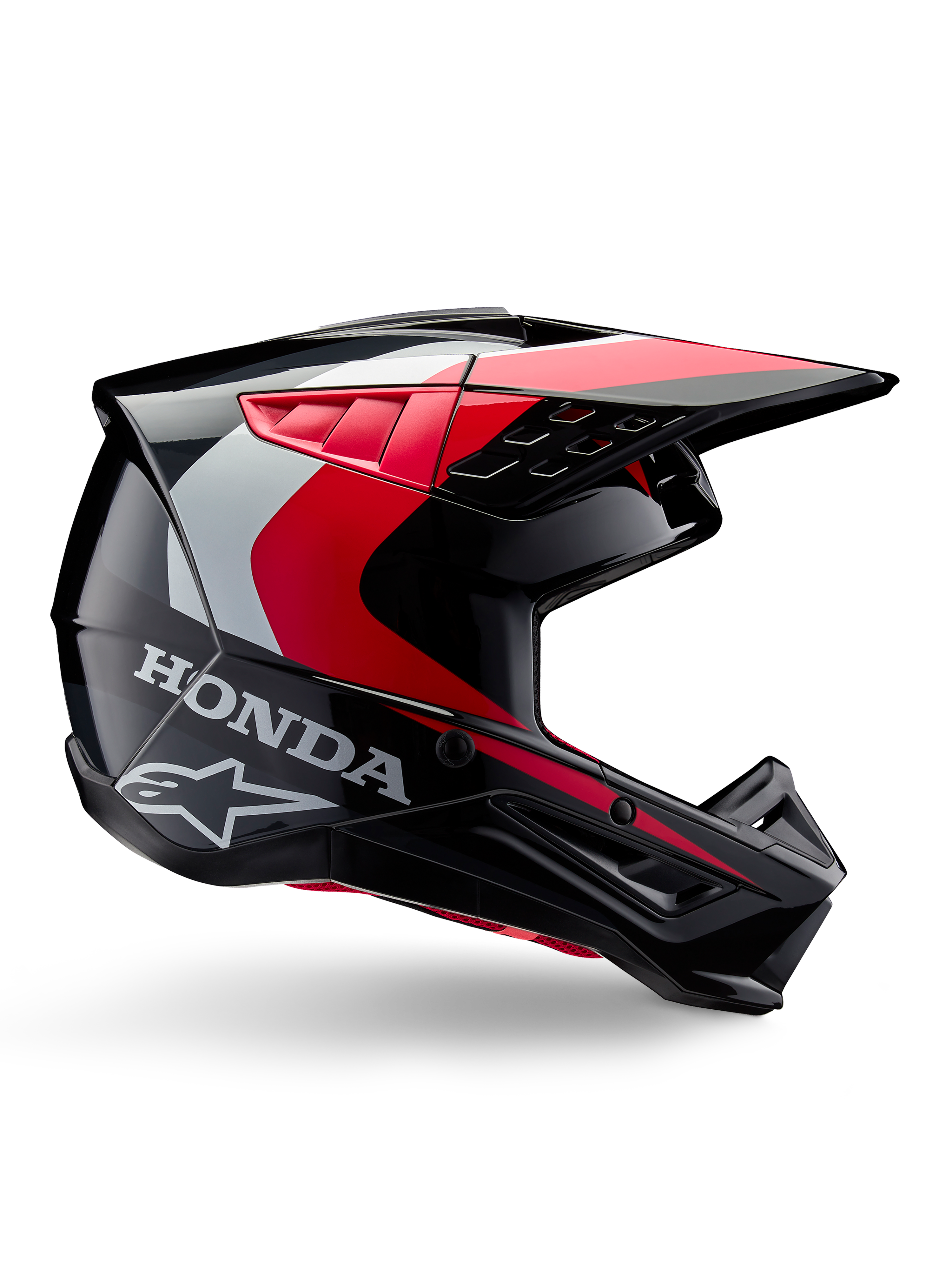 Honda S-M5 Helm, Motocross-Helm, Schwarz-Rot glänzend mit weißen und silbernen Akzenten, Seitenansicht mit Honda- und Alpinestars-Logos, aerodynamisches Design mit Visier und mehreren Belüftungsöffnungen, professionelle Offroad-Schutzausrüstung