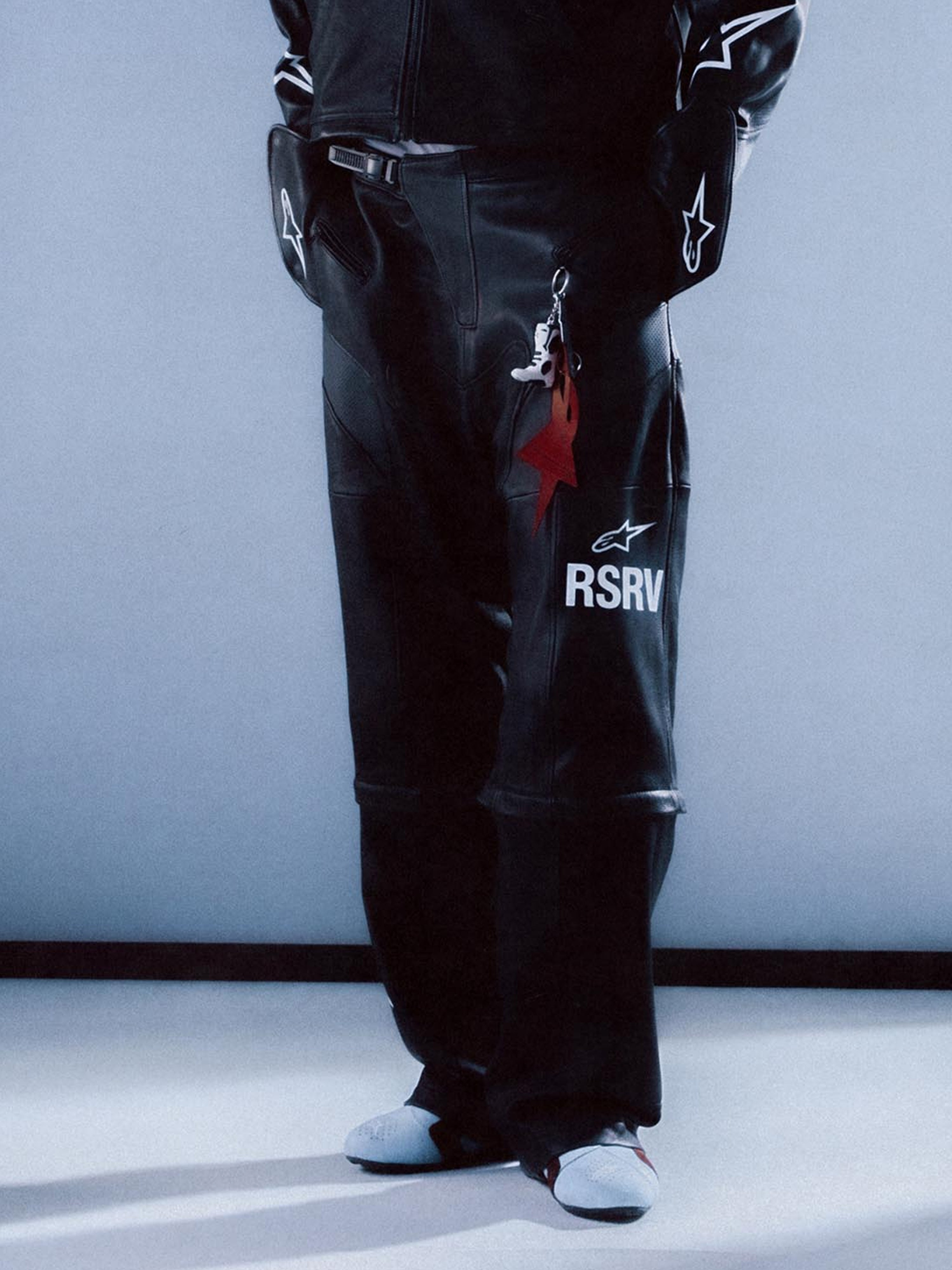 RSRV Neo Bat Leather Pants, Premium Black Leather Motorcycle Pants, Unisex Streetwear, White RSRV Logo Detail, Red Star Keychain Accent, Italian Craftsmanship, Luxury Motorsport Fashion