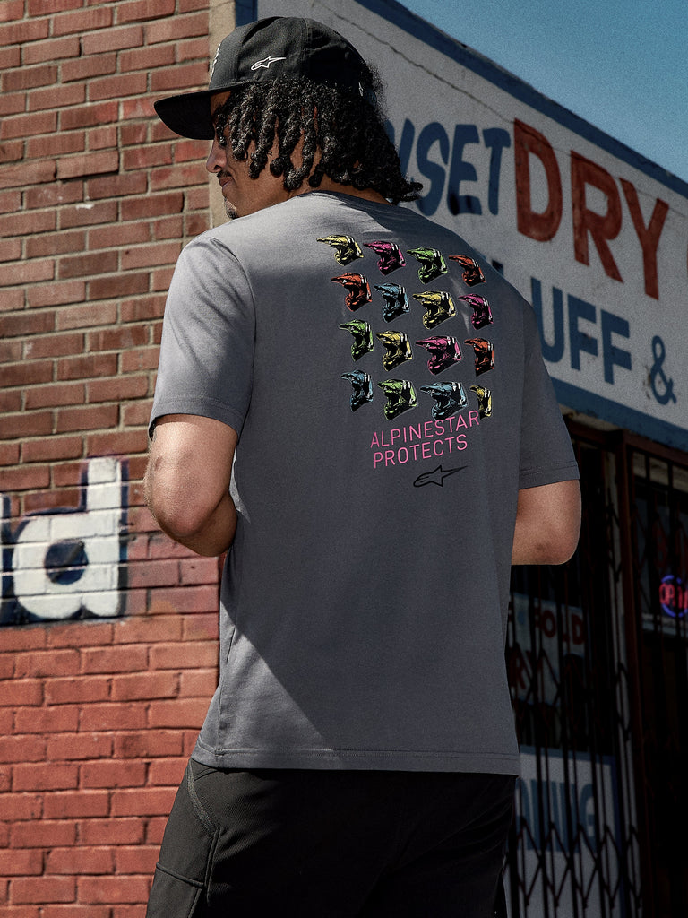 Alpinestars Pop Helmet CSF Tee, Short Sleeve T-Shirt, Charcoal Gray, back graphic featuring colorful M10 helmets and pink "ALPINESTAR PROTECTS" text, casual motorsport-inspired streetwear