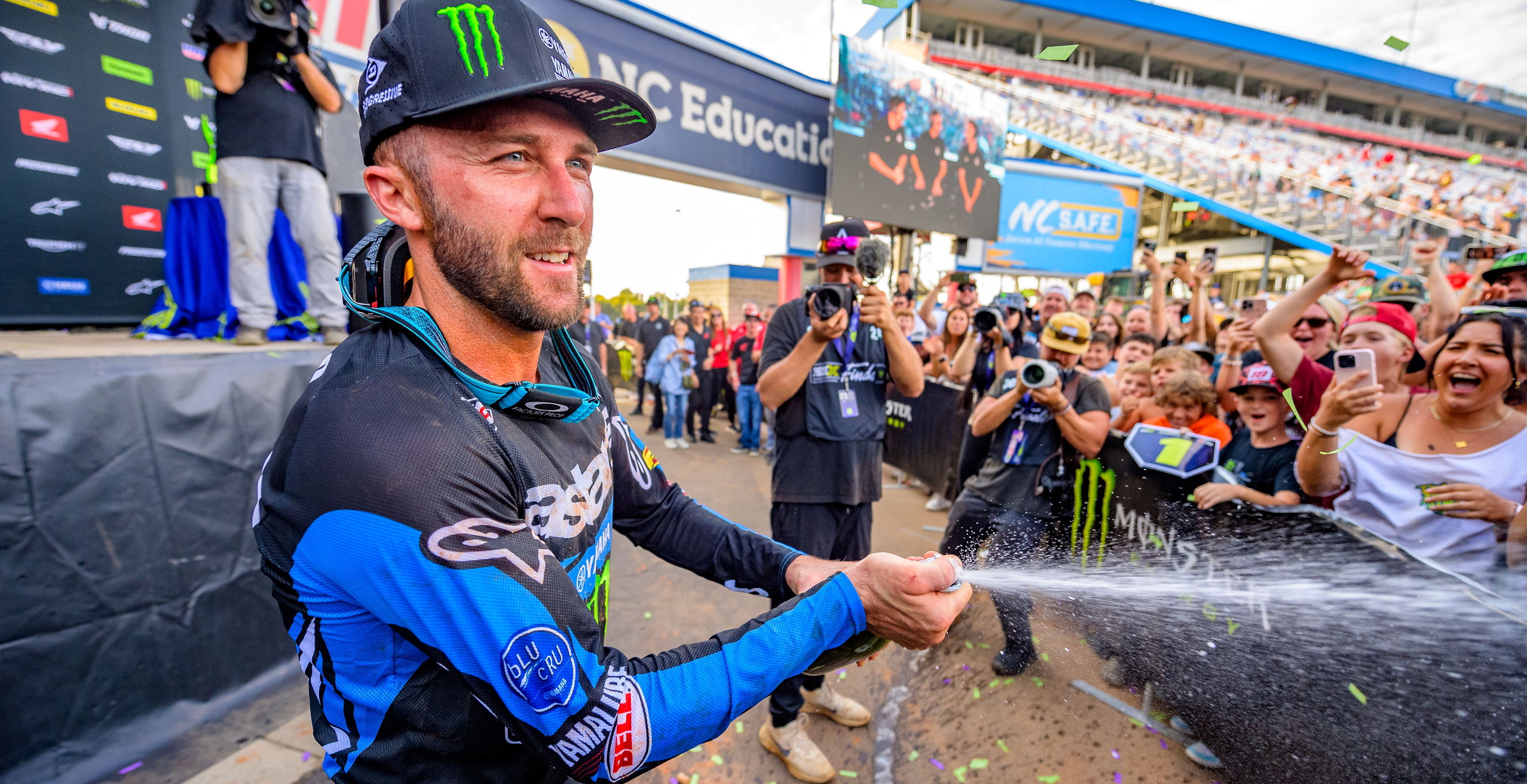 Eli Tomac spraying champagne to celebrate a race win 