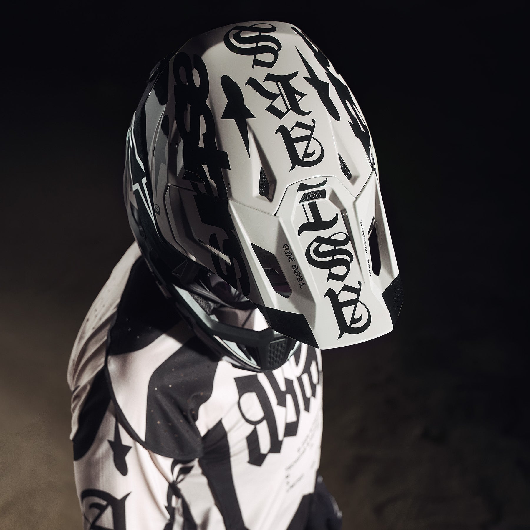 Alpinestars Limited Edition S-M7 Wolf Dust Helmet and Visor, black and white motocross gear with bold gothic graphics.