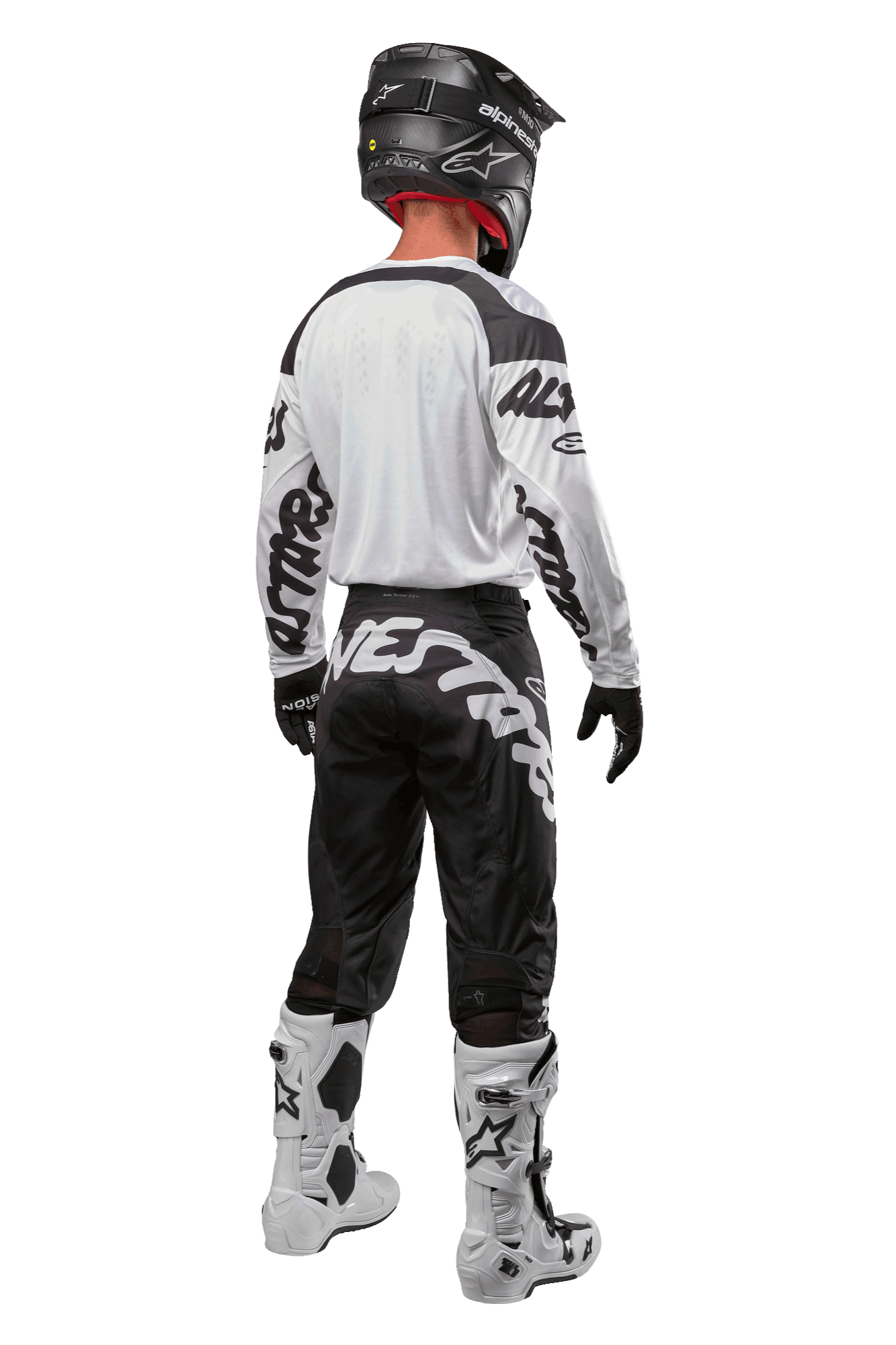 Alpinestars 2024 Racer Hana Hose, Motocross-Hose, Schwarz und Weiß mit markantem Logo-Schriftzug am Gesäß, Rückansicht der kompletten MX-Ausrüstung inklusive weißem Trikot und Stiefeln