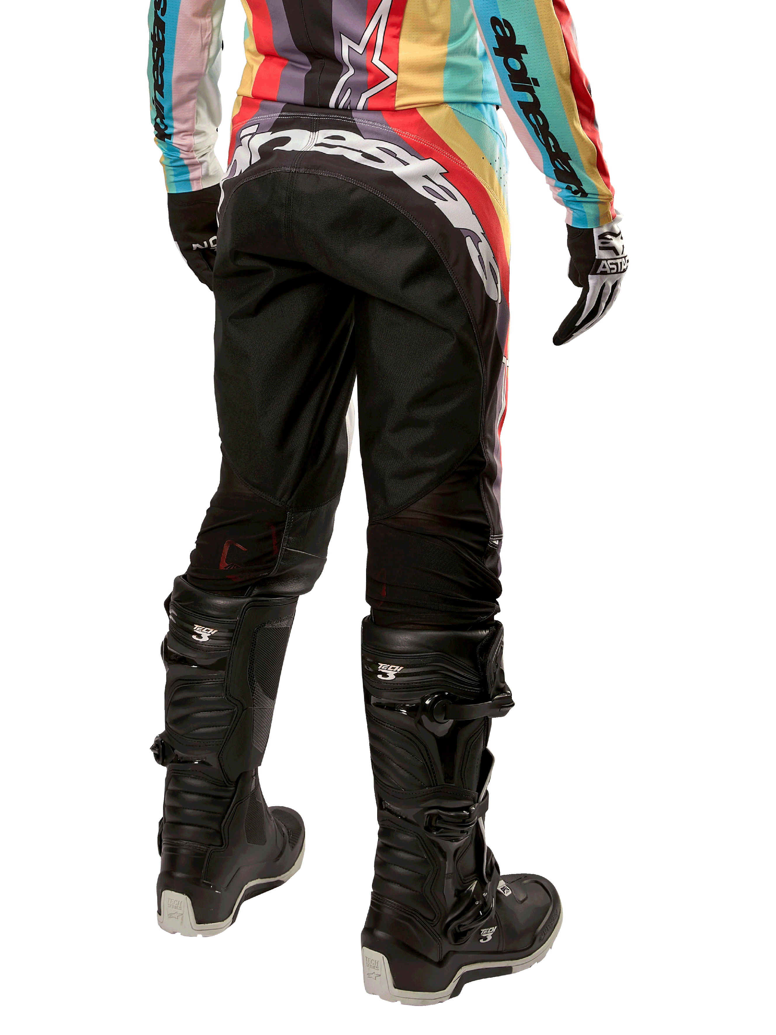 Alpinestars Damen Stella 2024 Techstar Hose, Motocross-Hose, Schwarz-Mehrfarbig, Rückansicht mit markantem weißem Branding auf dem Gesäß, getragen mit schwarzen Tech 3 Stiefeln und passendem mehrfarbigem Trikot, professionelle Offroad-Rennbekleidung.