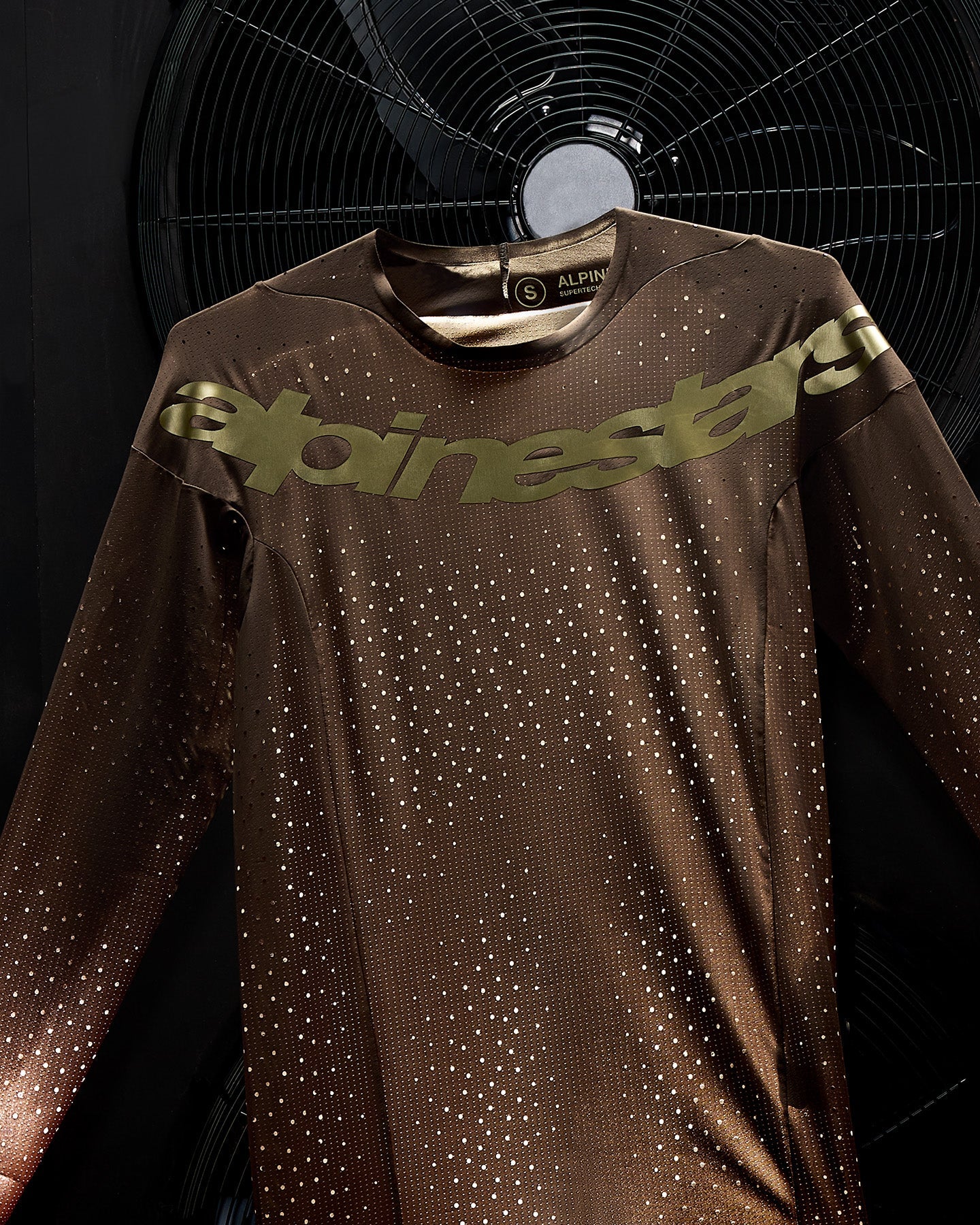 Alpinestars Supertech Air Gold Jersey, ventilated motocross racing top in Earth Brown and Gold with perforated fabric.