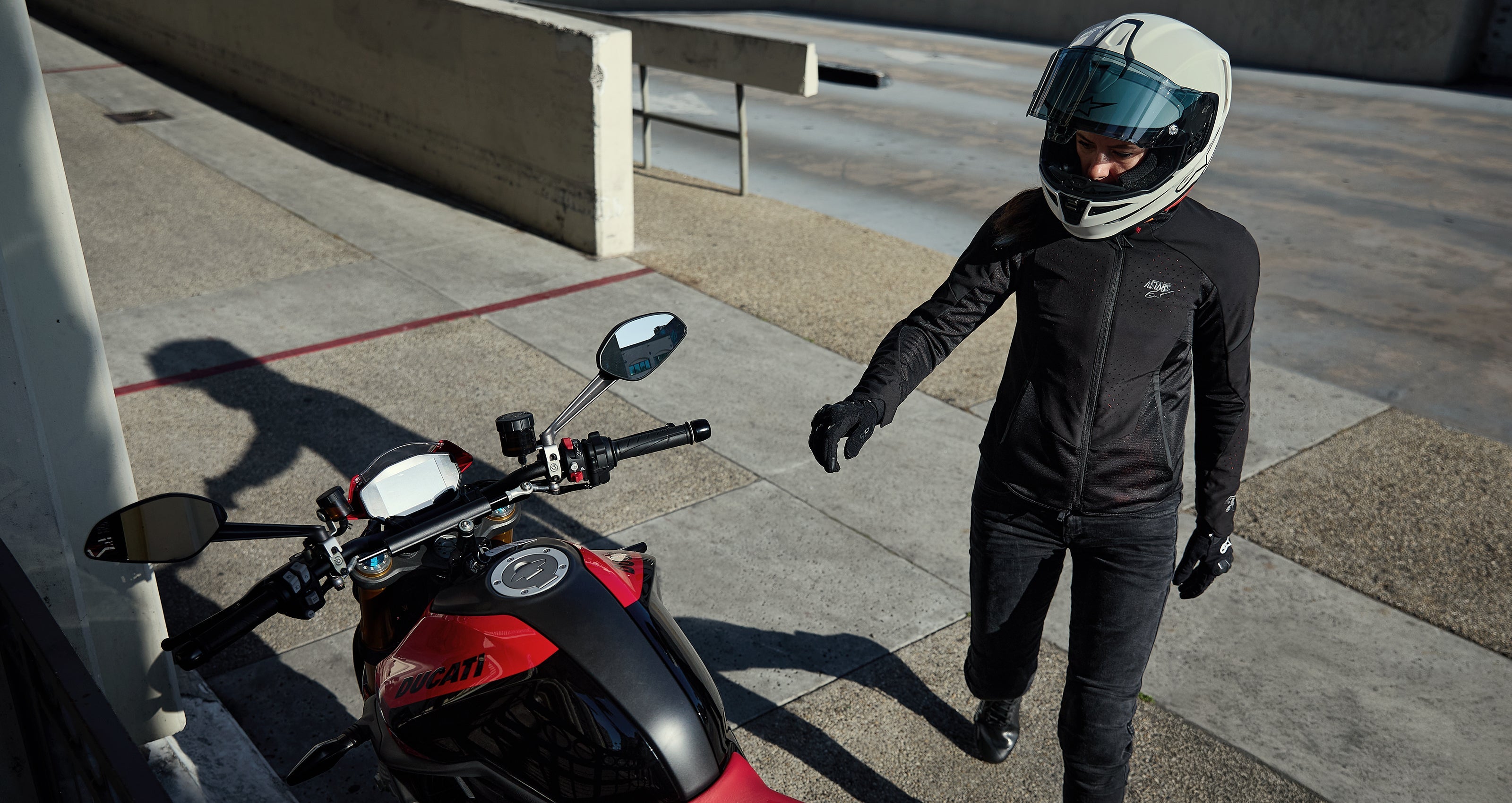 Alpinestars Stella Aeroshell Airflow Jacket, Women's Black Vented Softshell for Urban Riding near a Red Ducati.