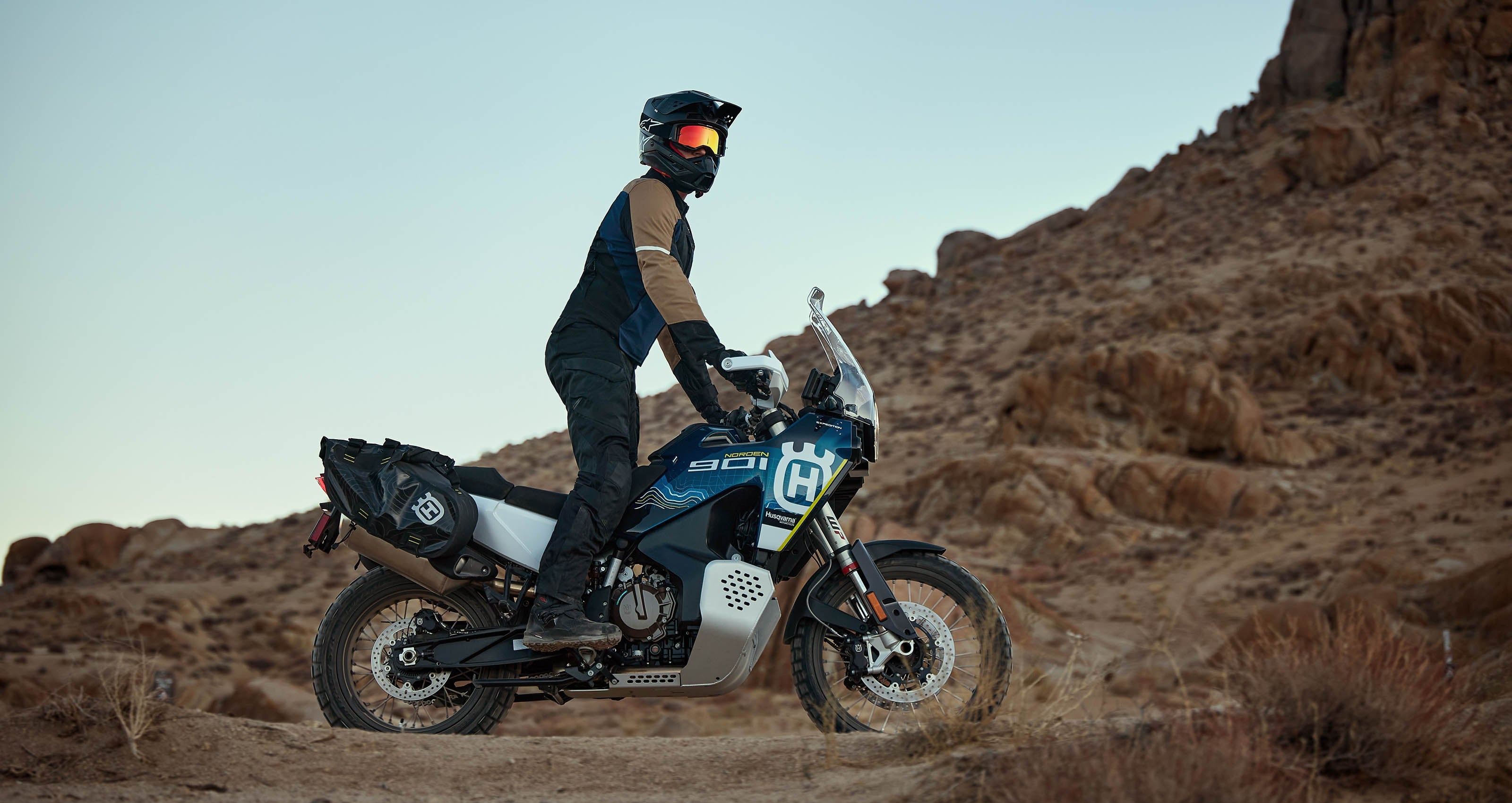 Alpinestars ST-2 Air Jacket in black and tan, designed for adventure touring, worn by a rider in the desert.