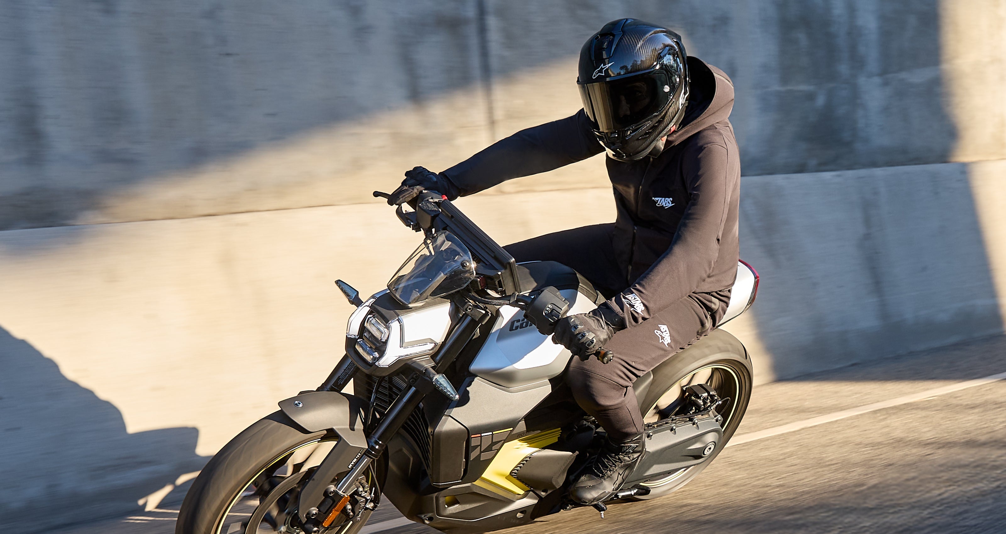 Alpinestars Aeroshell Waterproof Jacket AND Aeroshell Pants, Black softshell motorcycle gear for road riding on a modern bike.