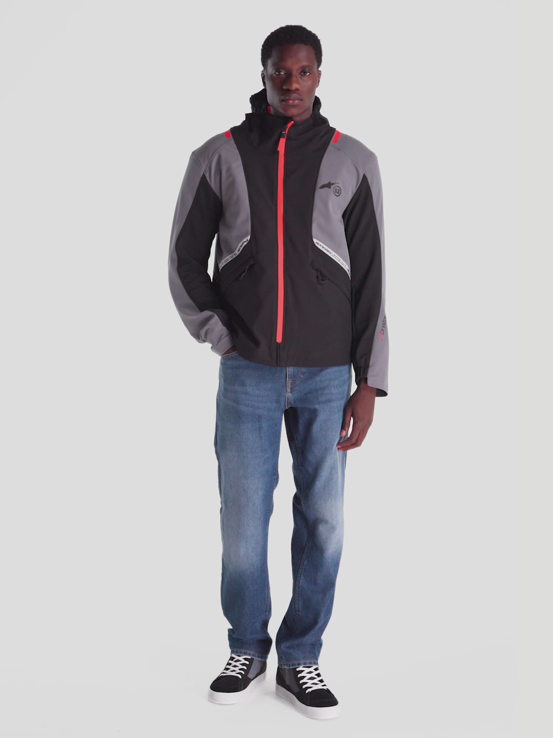 Alpinestars C-5 Drystar Jacket, men's urban motorcycle textile jacket in black and dark gray with red accents, front view on a model wearing the waterproof softshell riding jacket with integrated hood and CE certified protection.