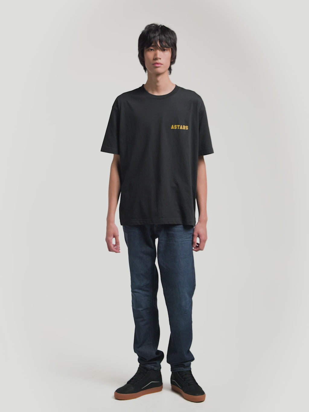 Alpinestars Latitude Oversized CSF Tee, Black Short Sleeve Sportswear T-Shirt, Unisex Oversized Fit, Yellow ASTARS Front Wordmark and Multi-Color Back Globe Graphic, Cotton-Poly Blend, On-Model Front and Back Views.
